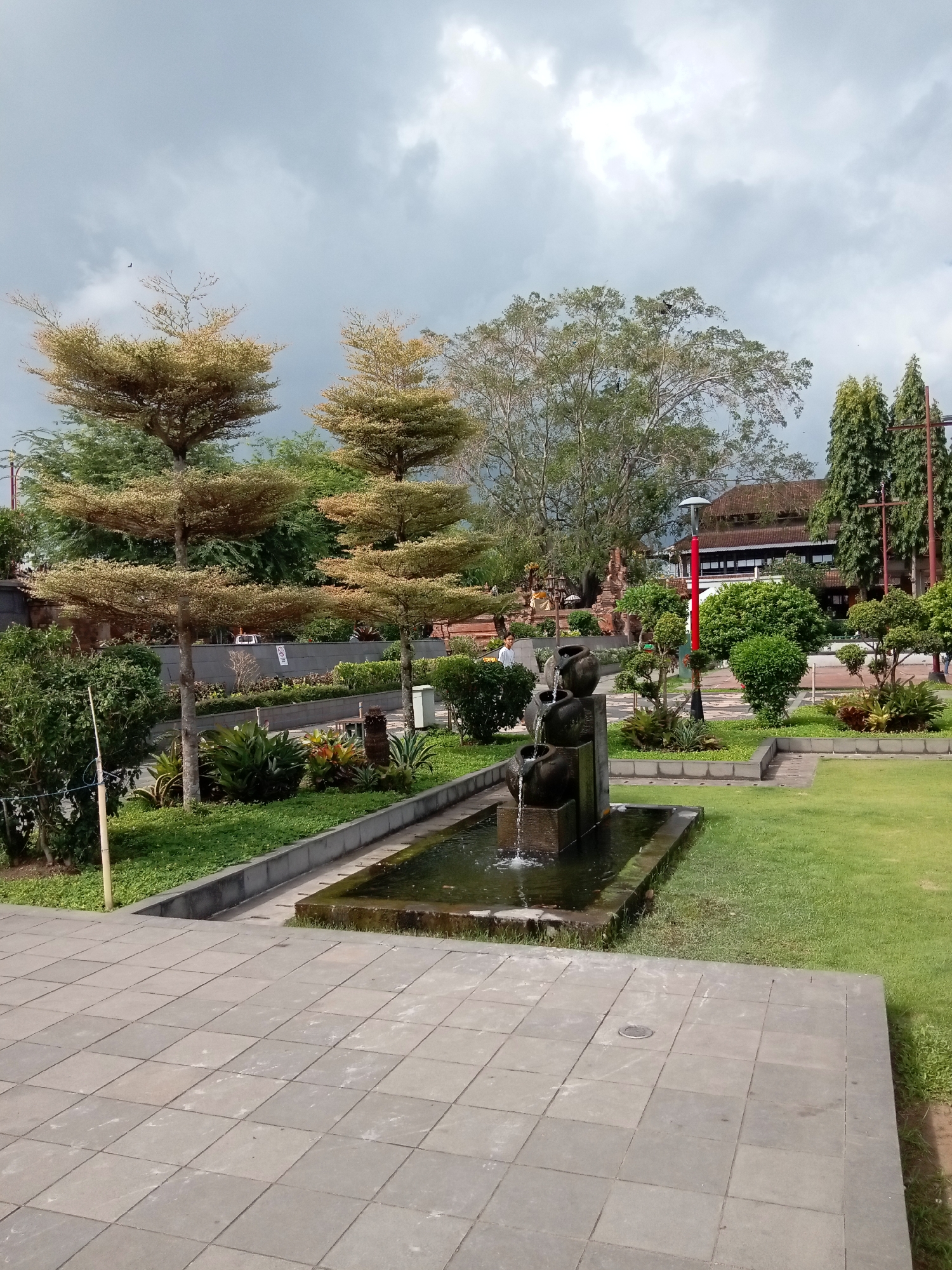 Balinese civic grounds in Gianyar, soldiers marching and statues on display
