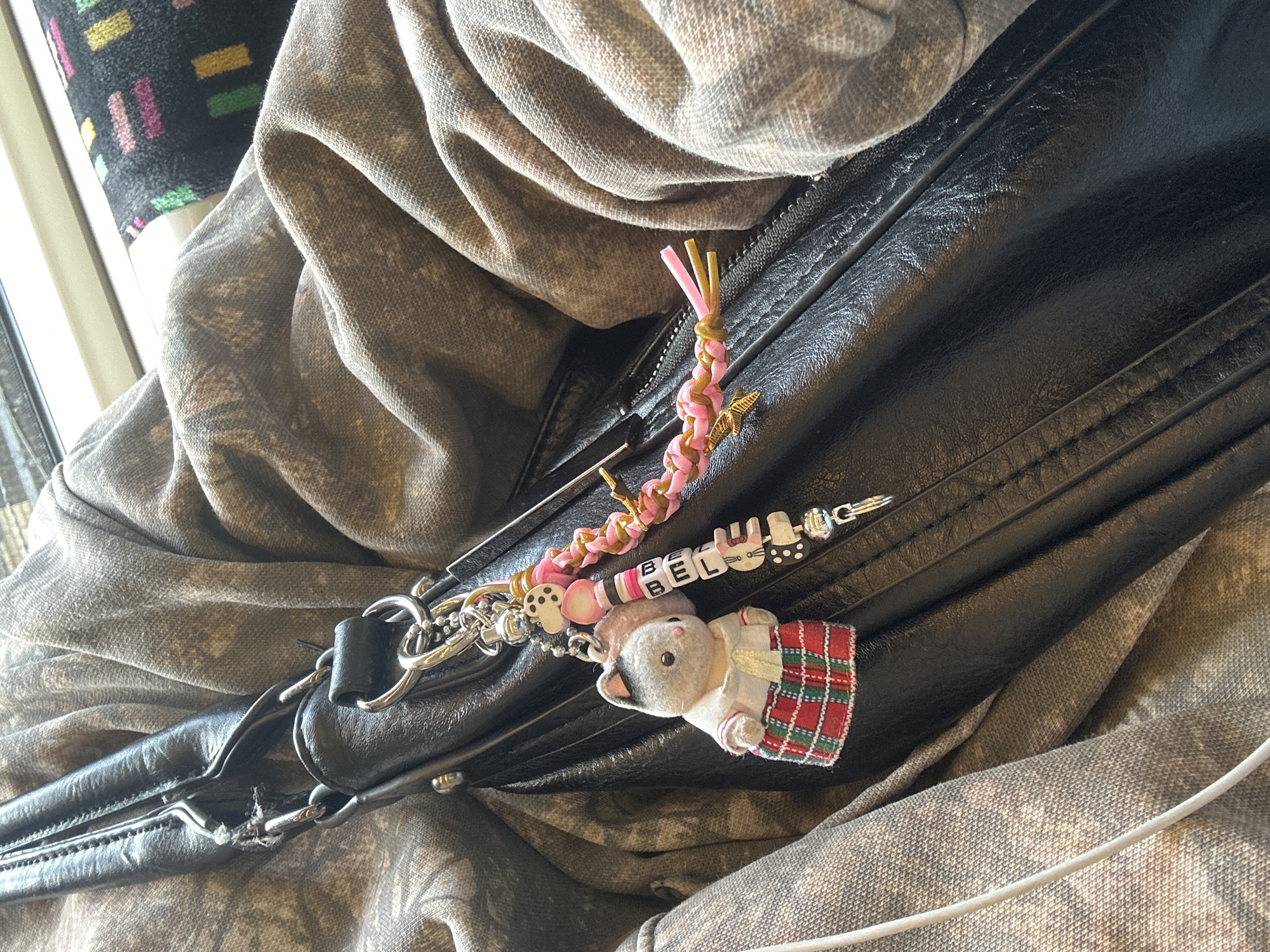 Black leather bag spotted on London public transport seat