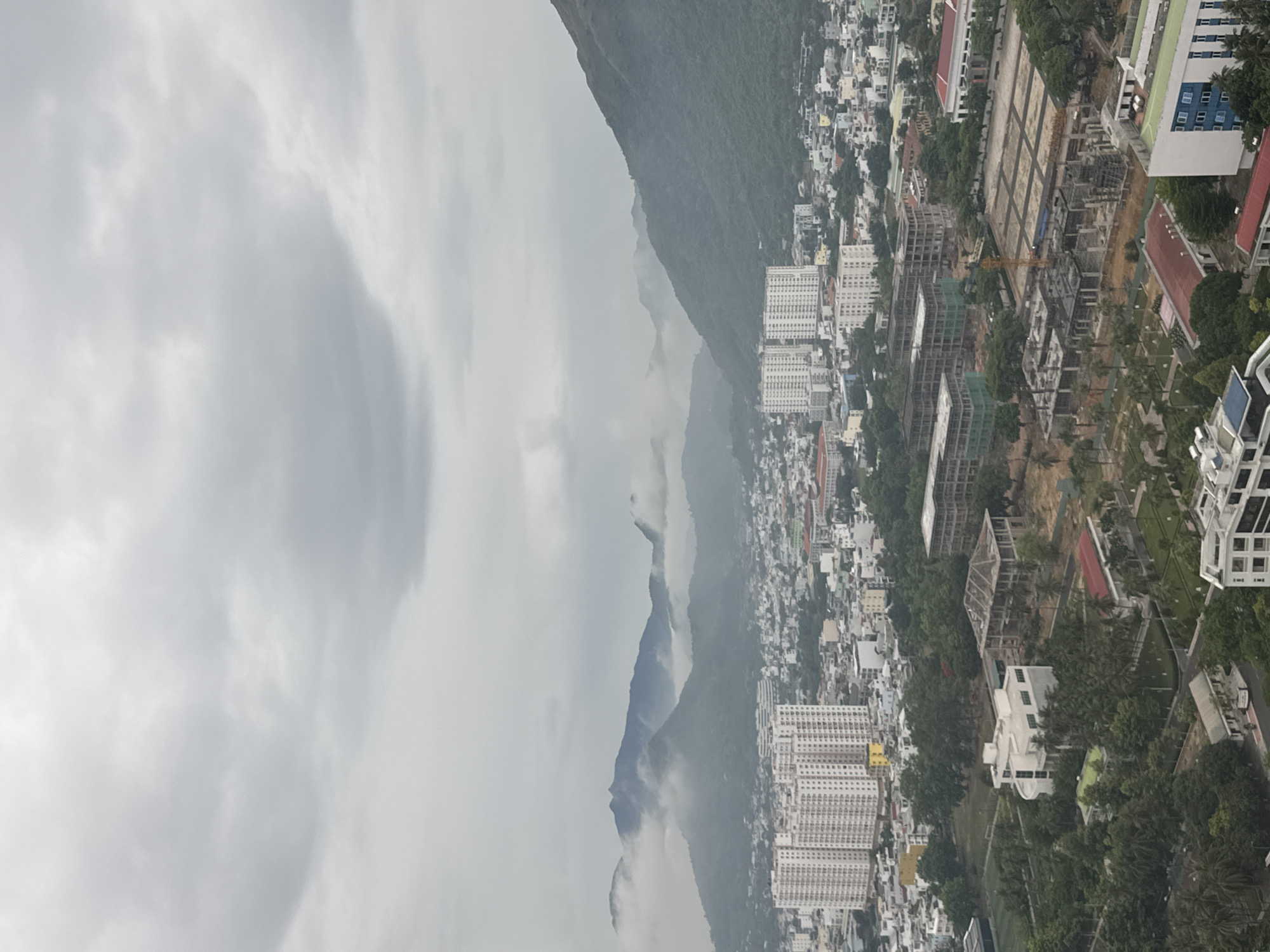 Aerial tour of a misty coastal city with gothic church