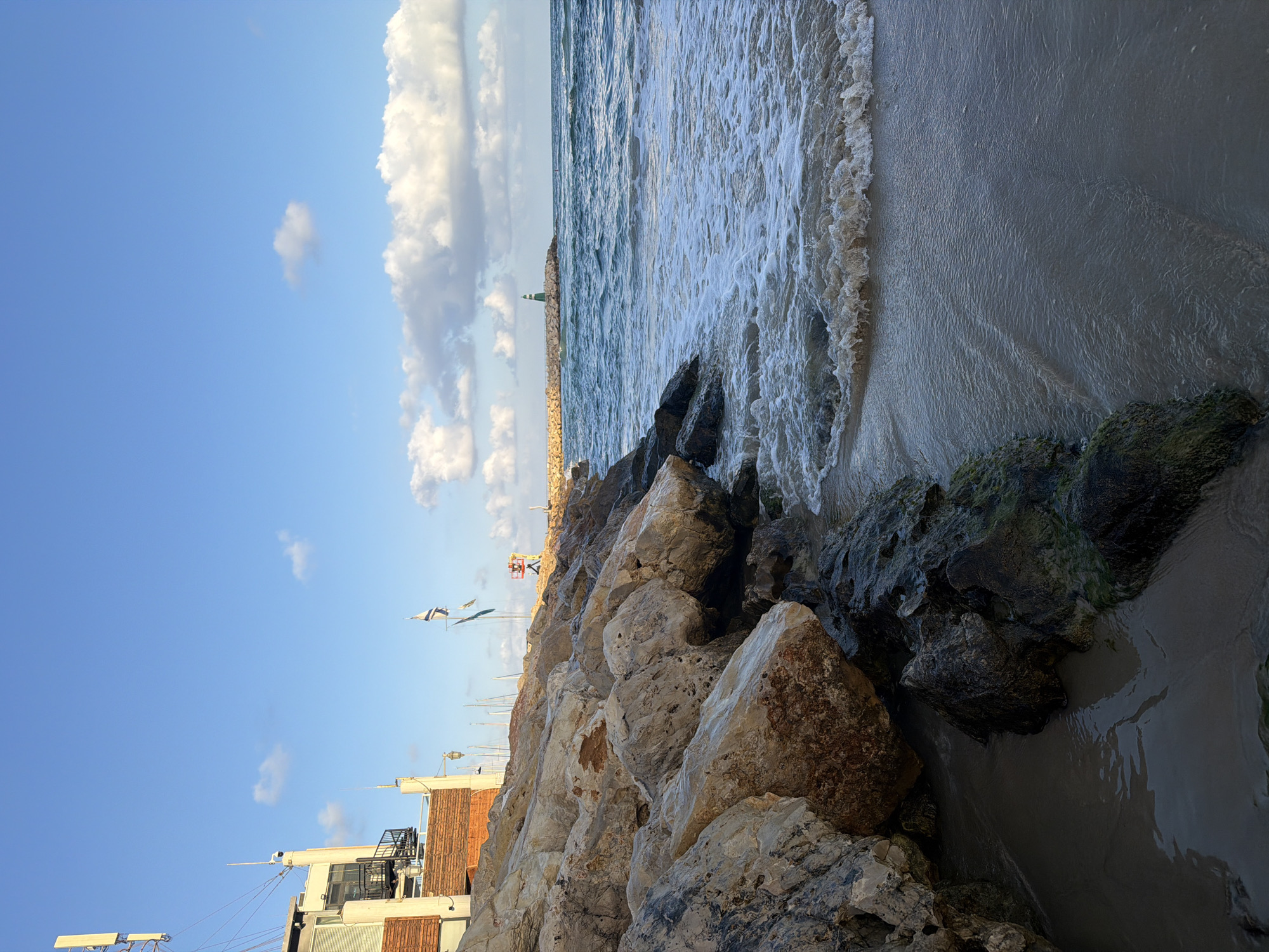 Rocky Tel Aviv shoreline, speaker and camera in hand