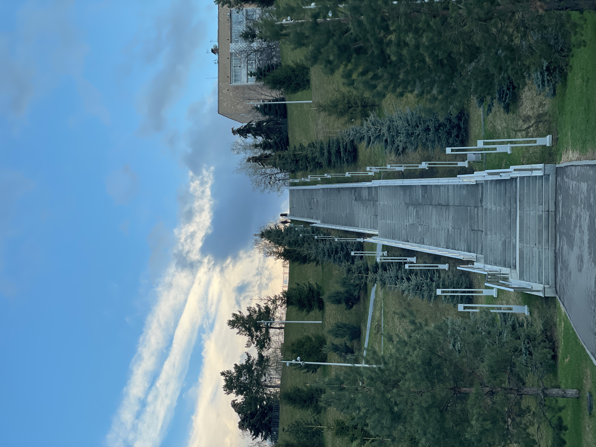Urban waterfront park and skyline documented under cloudy skies