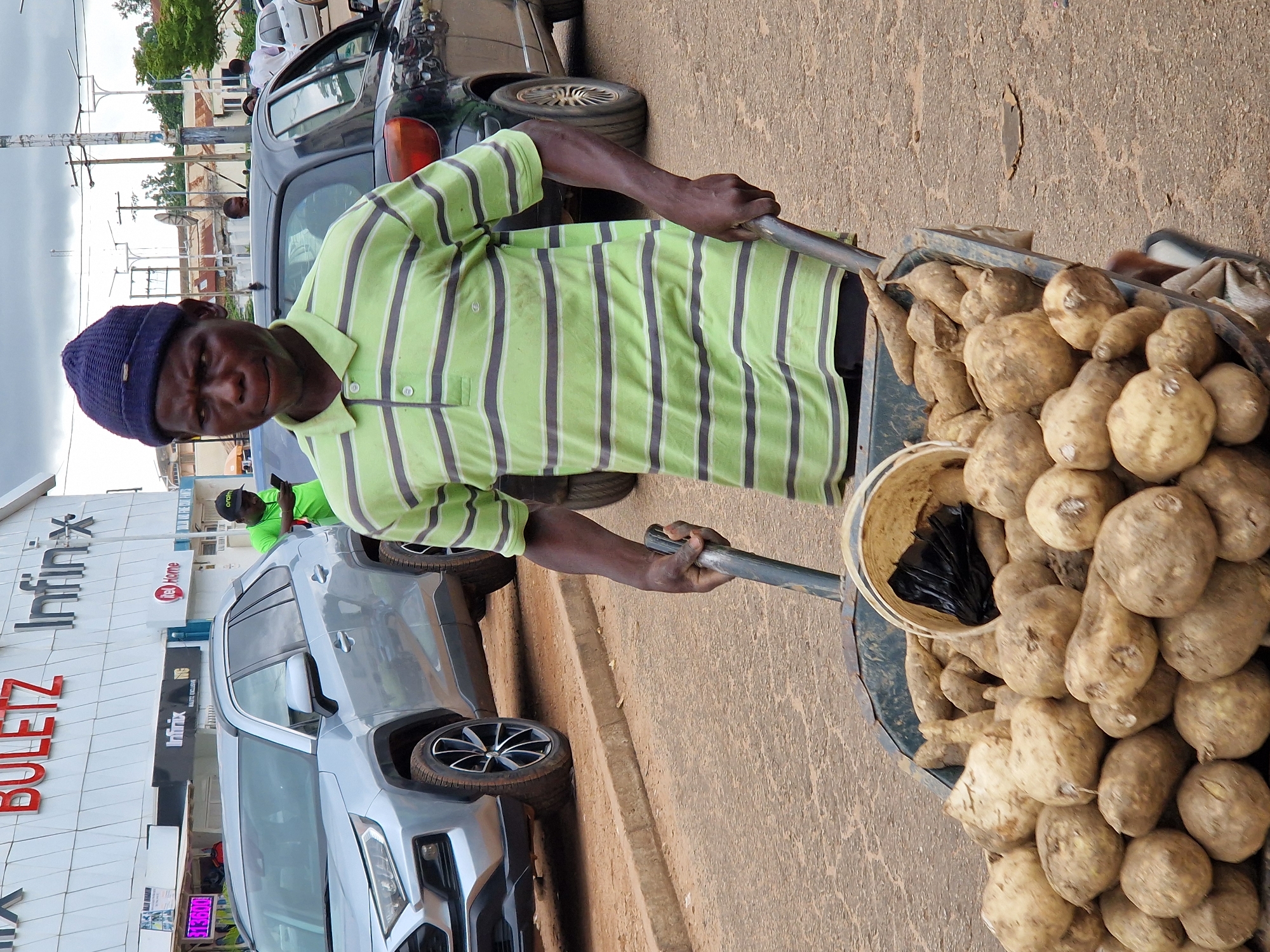 Street vendors and pedestrians move through a busy urban area