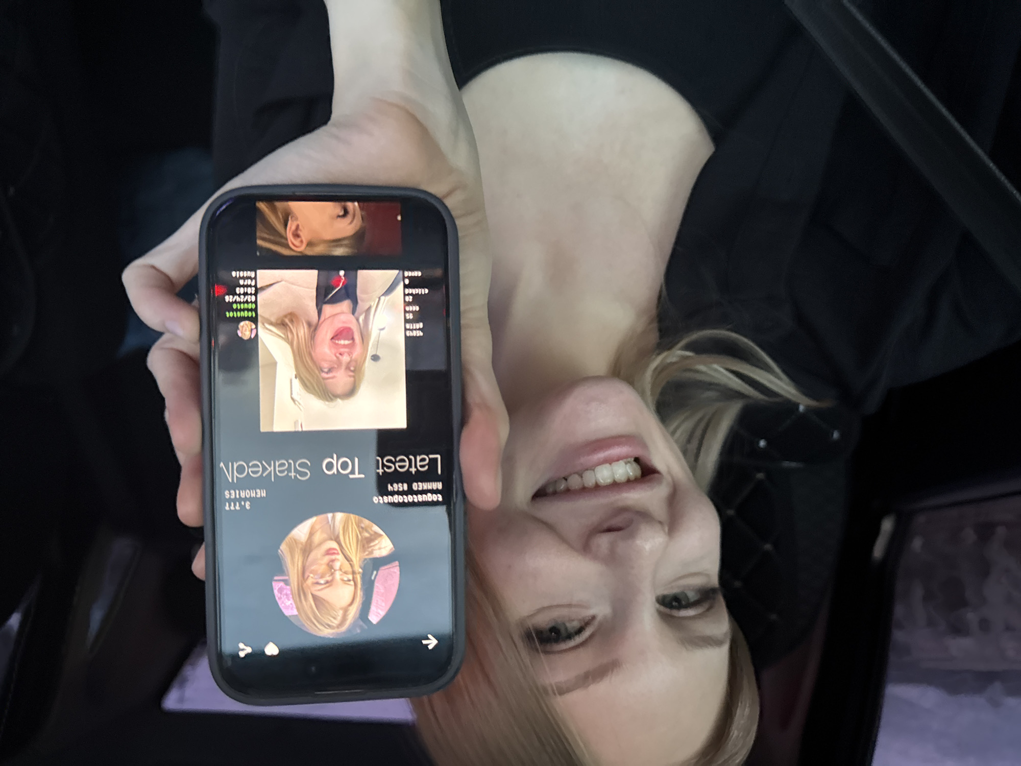 Woman reviews social media profile in car in Perm