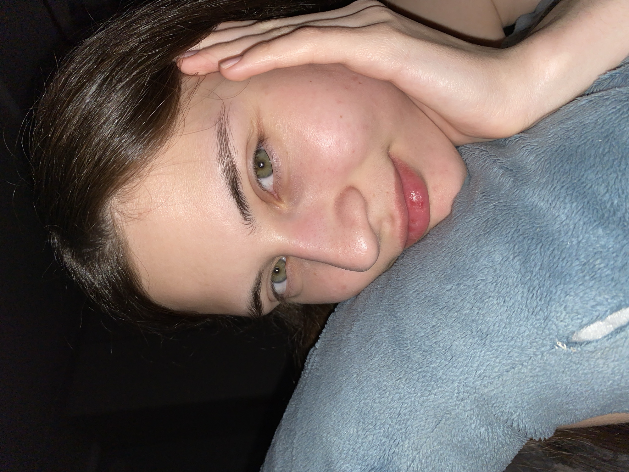 Woman takes selfies with sleeping dog on bed in Votkinsk