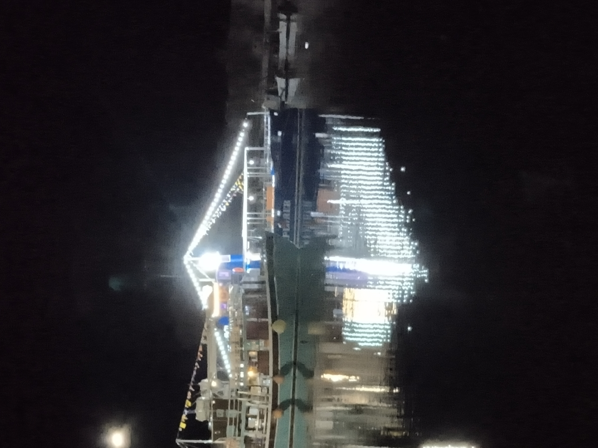 Limenaria harbor glows with string lights on a summer night.