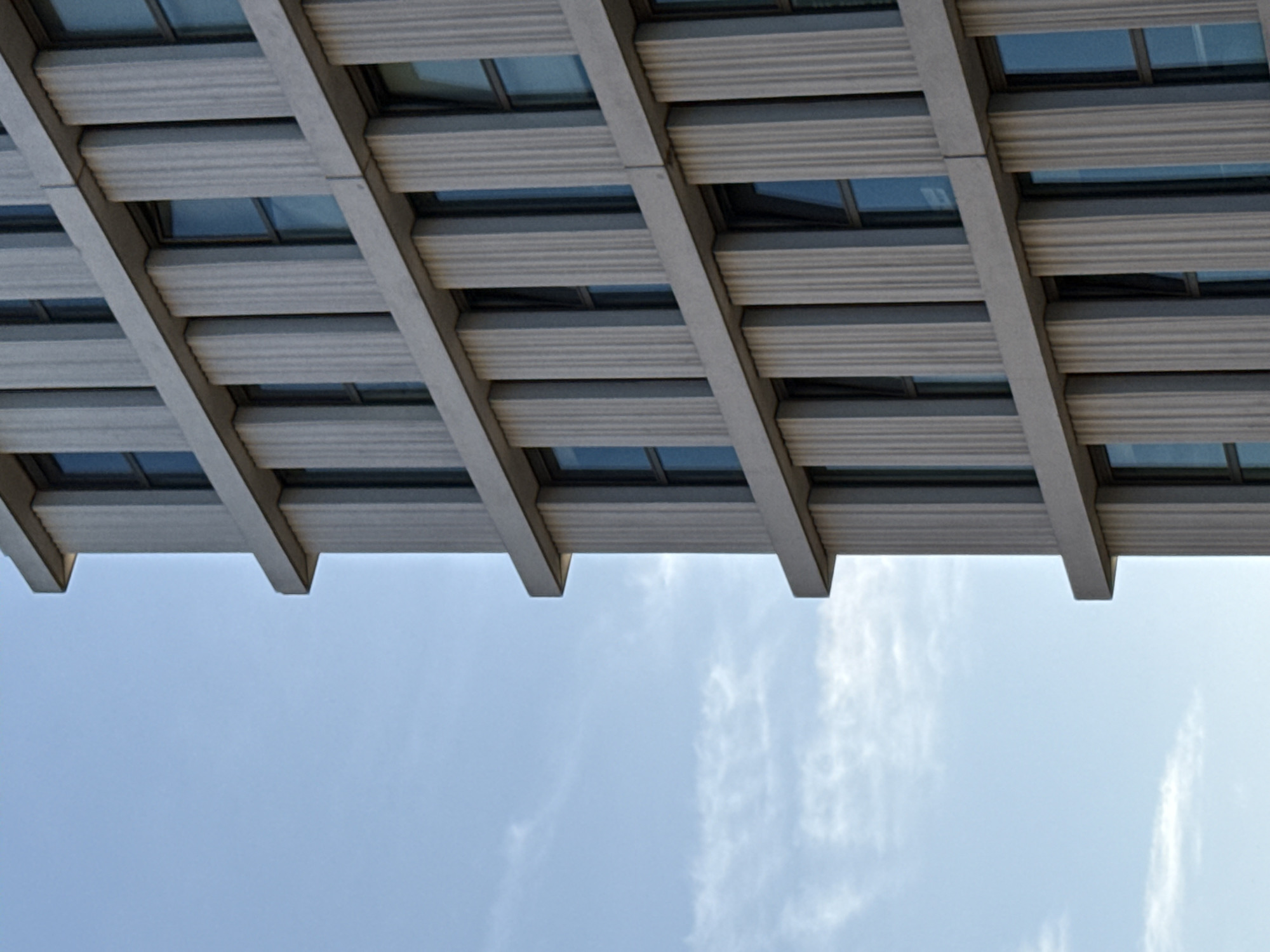 Brutalist concrete facade in Bruges, shot from below