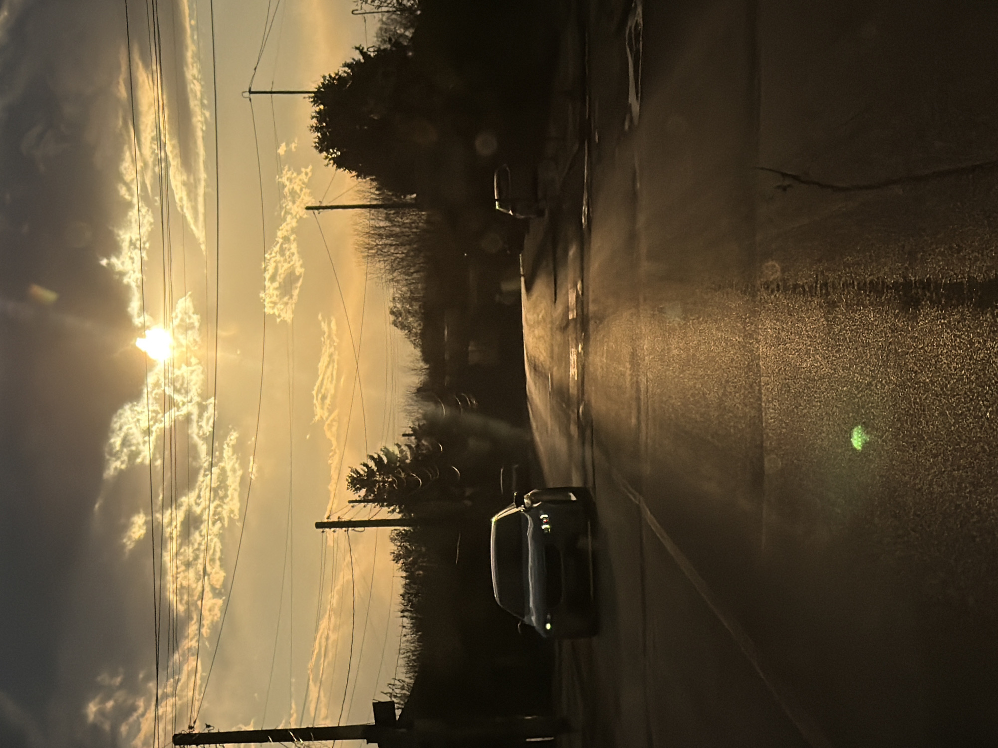 Golden sunset breaks through clouds over Bulgarian village streets