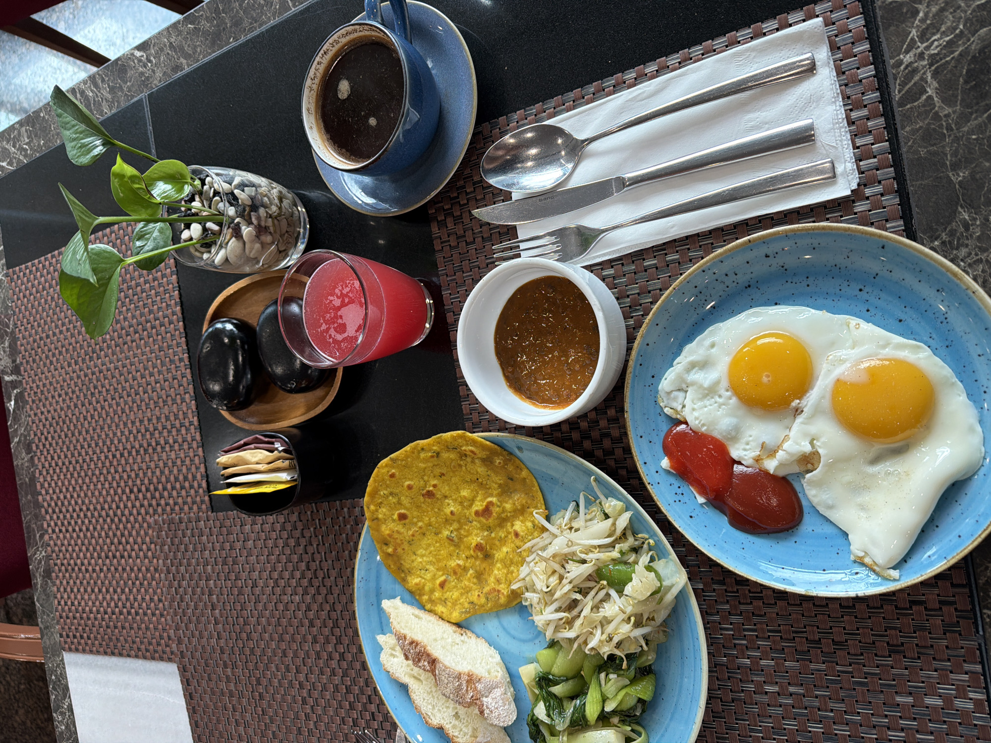 Breakfast scene documented in South Jakarta with coffee, plant