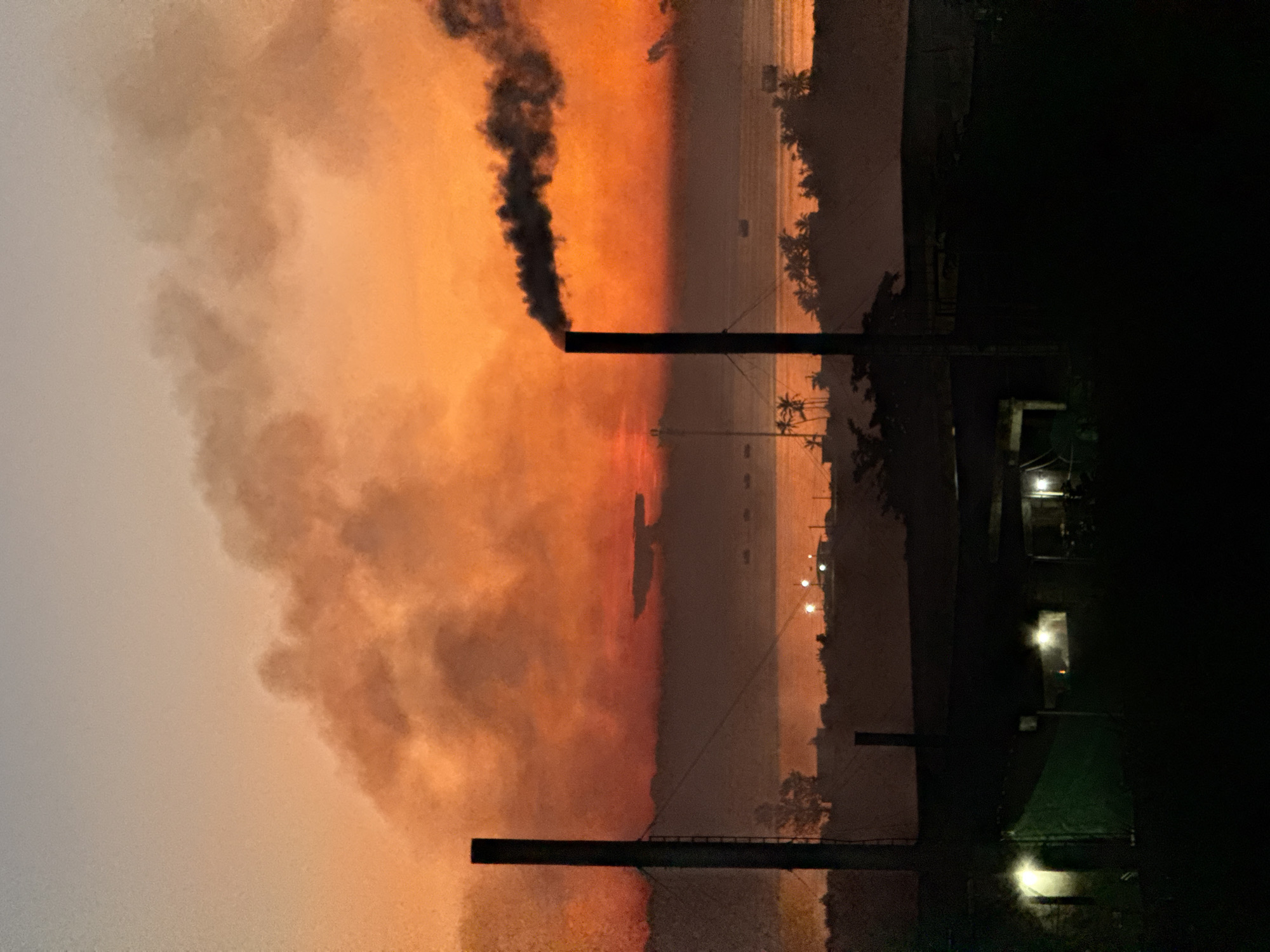 Smokestacks and fishing boats at sunset, Lý Sơn Island
