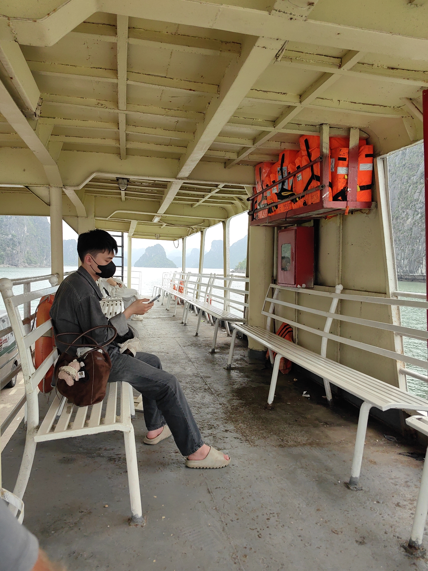 Masked passenger rides ferry in Vietnam's Bai Chay Ward