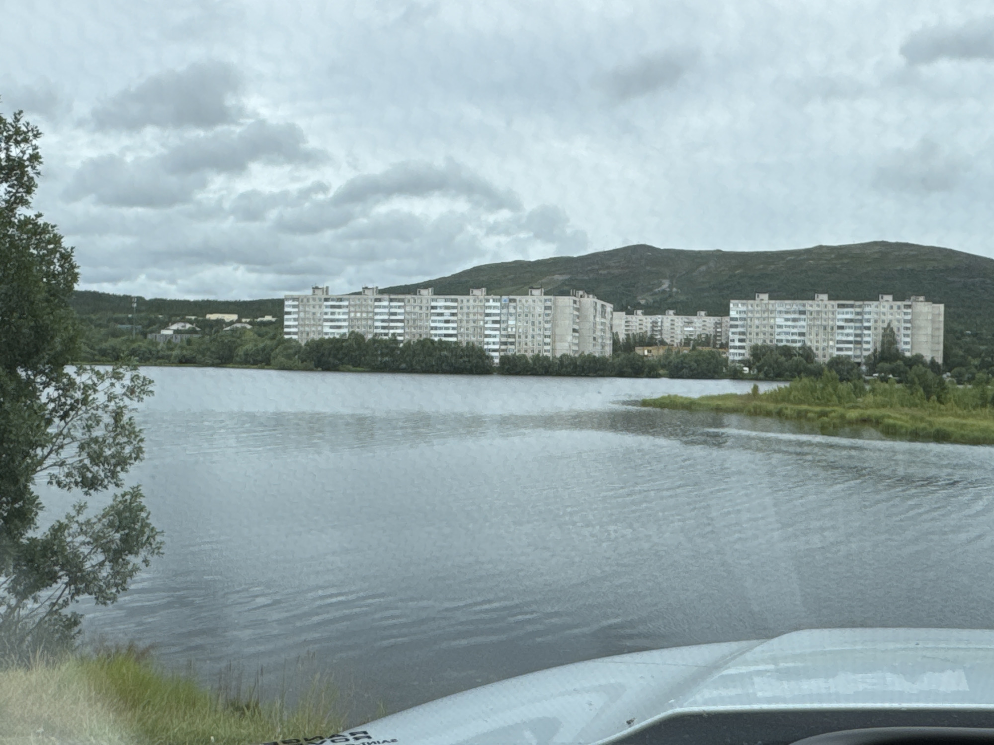 Still water and overcast skies at a quiet urban waterfront