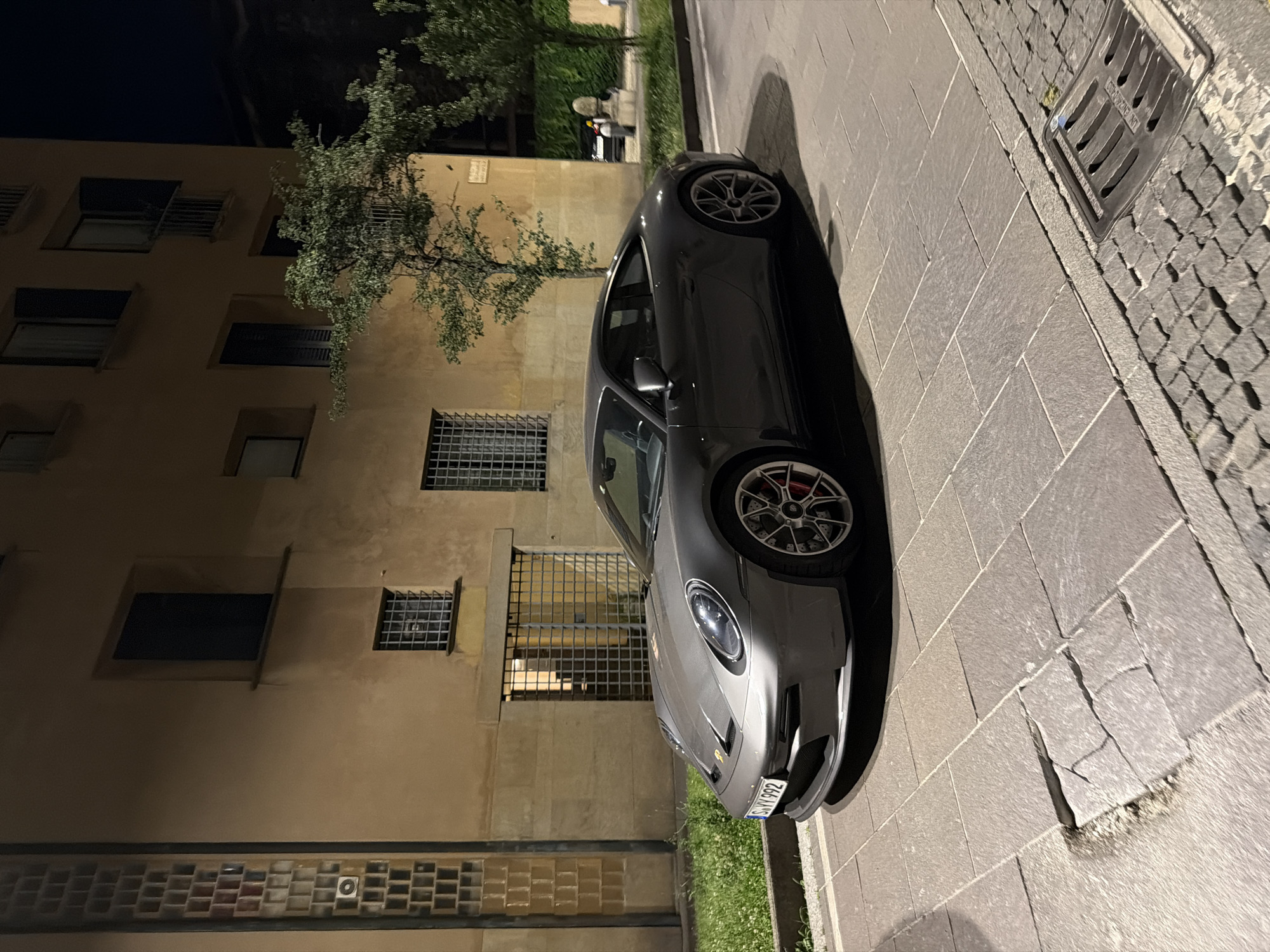 Evening dining documented at Milan restaurant, sports car nearby