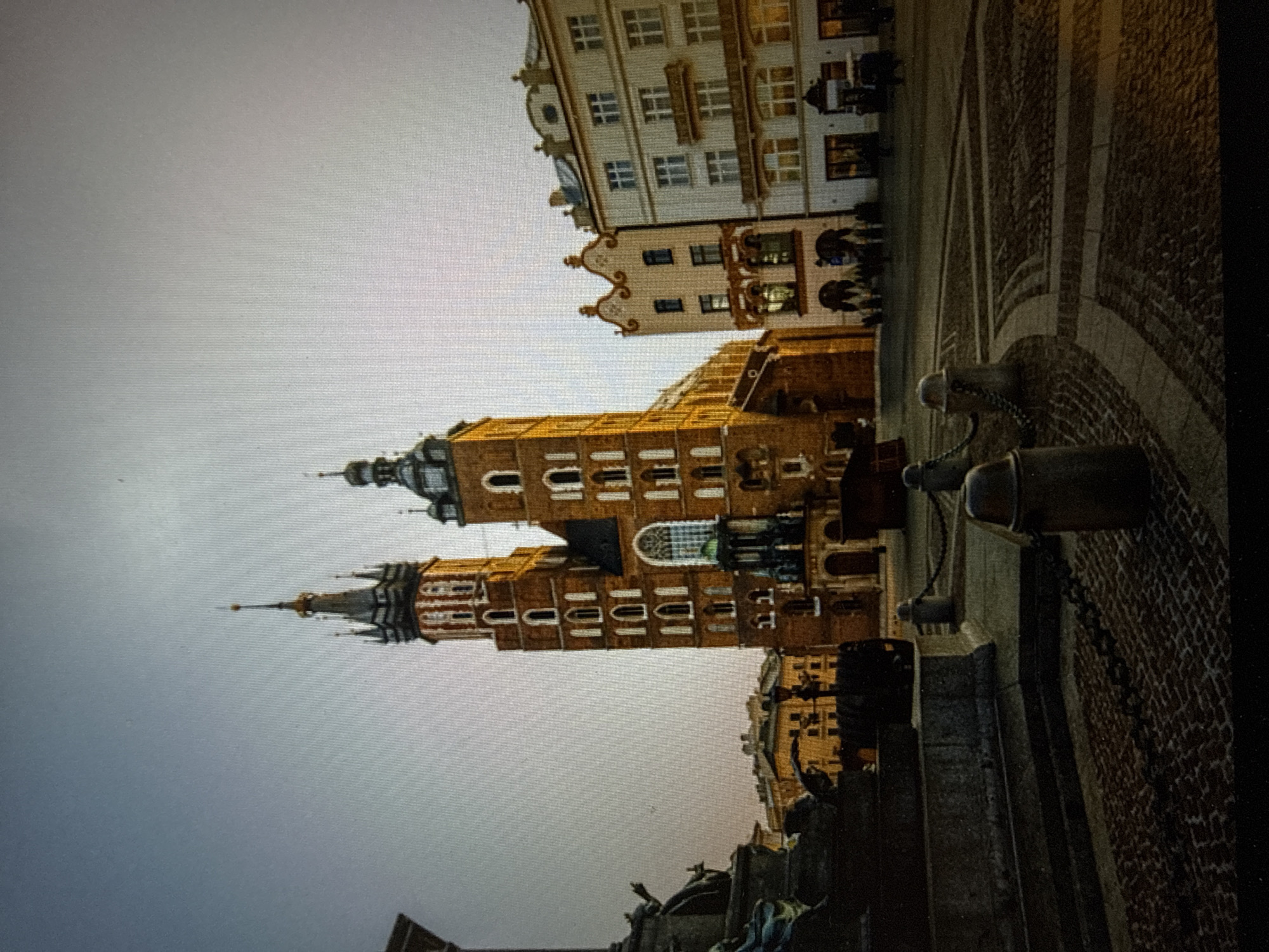 Morning documentation of Kraków basilica and waterfront reflections in Poland