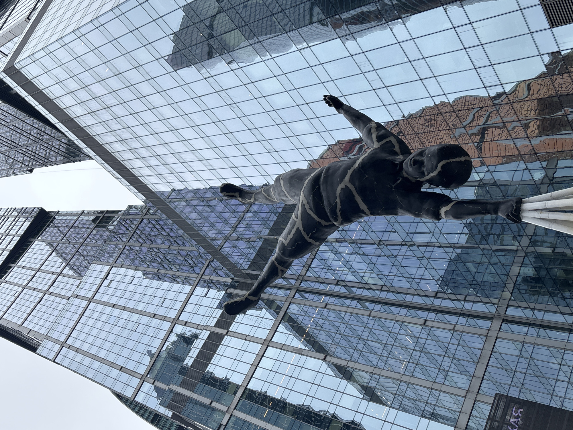 Woman visits Moscow City business district amid sculptures, building maintenance