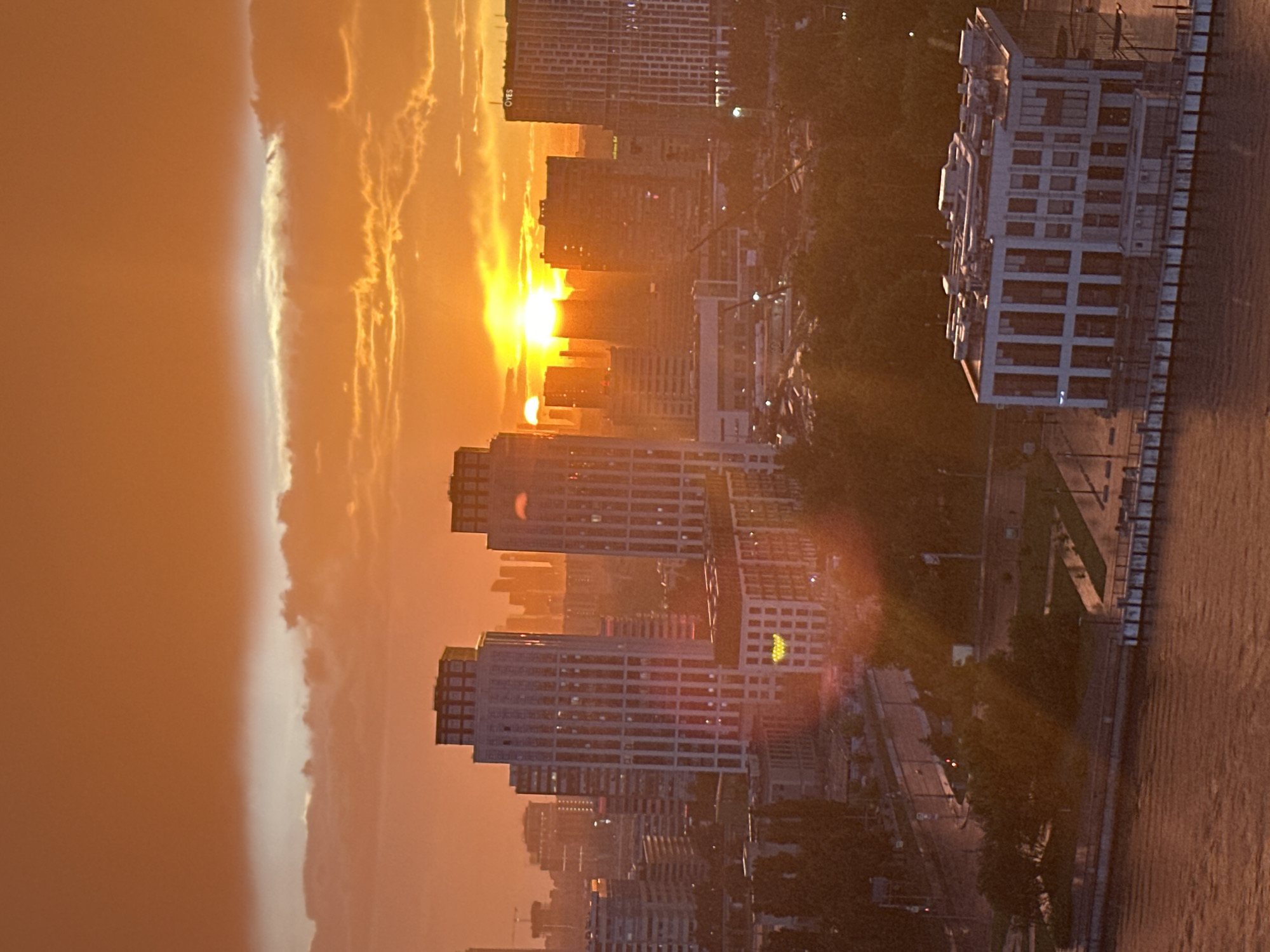 Moscow skyline glows at sunset, river and rooftops in frame