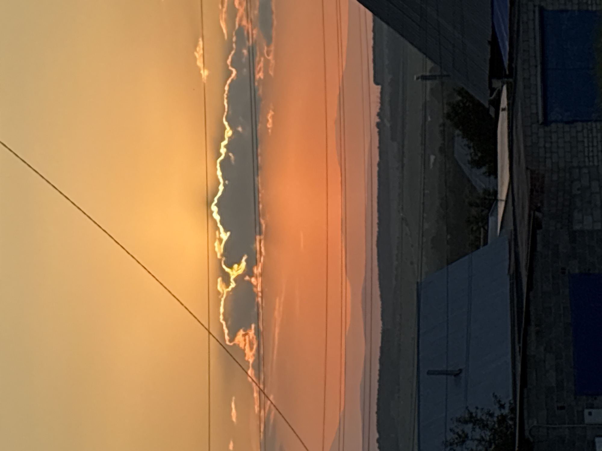 Vivid summer sunset over a neighborhood, power lines and all