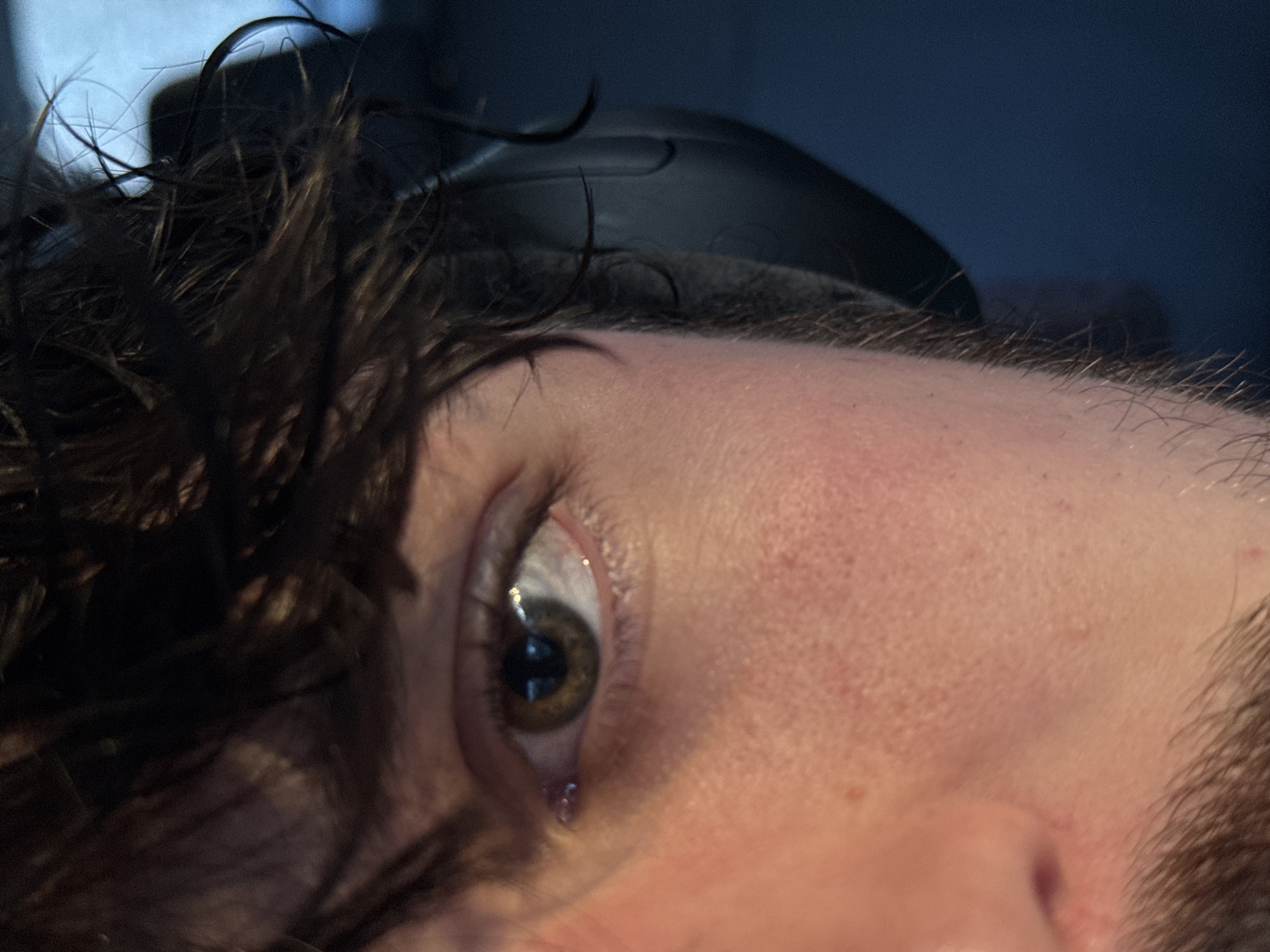 Close-up captures person with visible tear in emotional moment