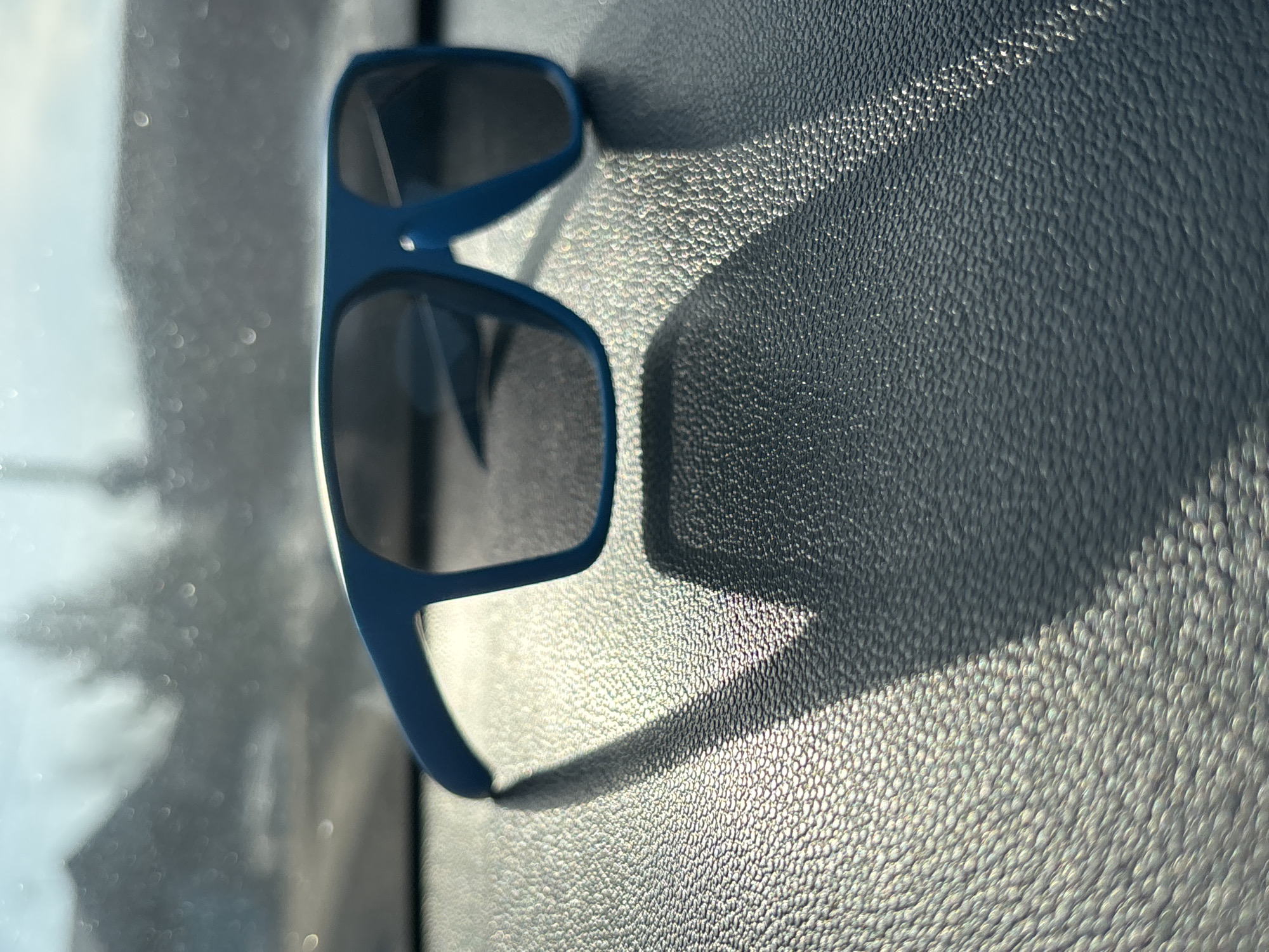 Blue sunglasses on vehicle dashboard in Chaikovsky, Russia