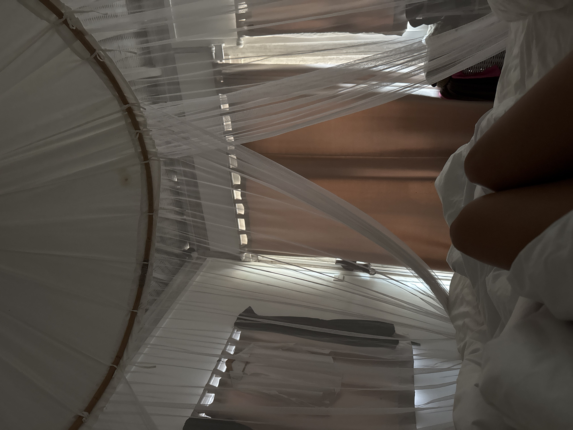 Bedroom interior with mosquito net documented in Indonesia