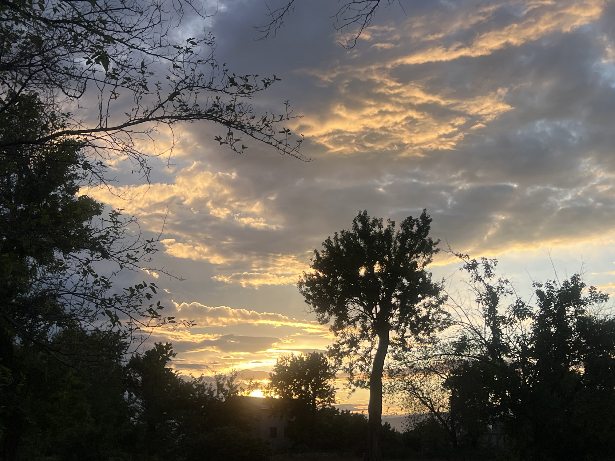 Dramatic sunset illuminates cloudy sky over Yerevan, Armenia