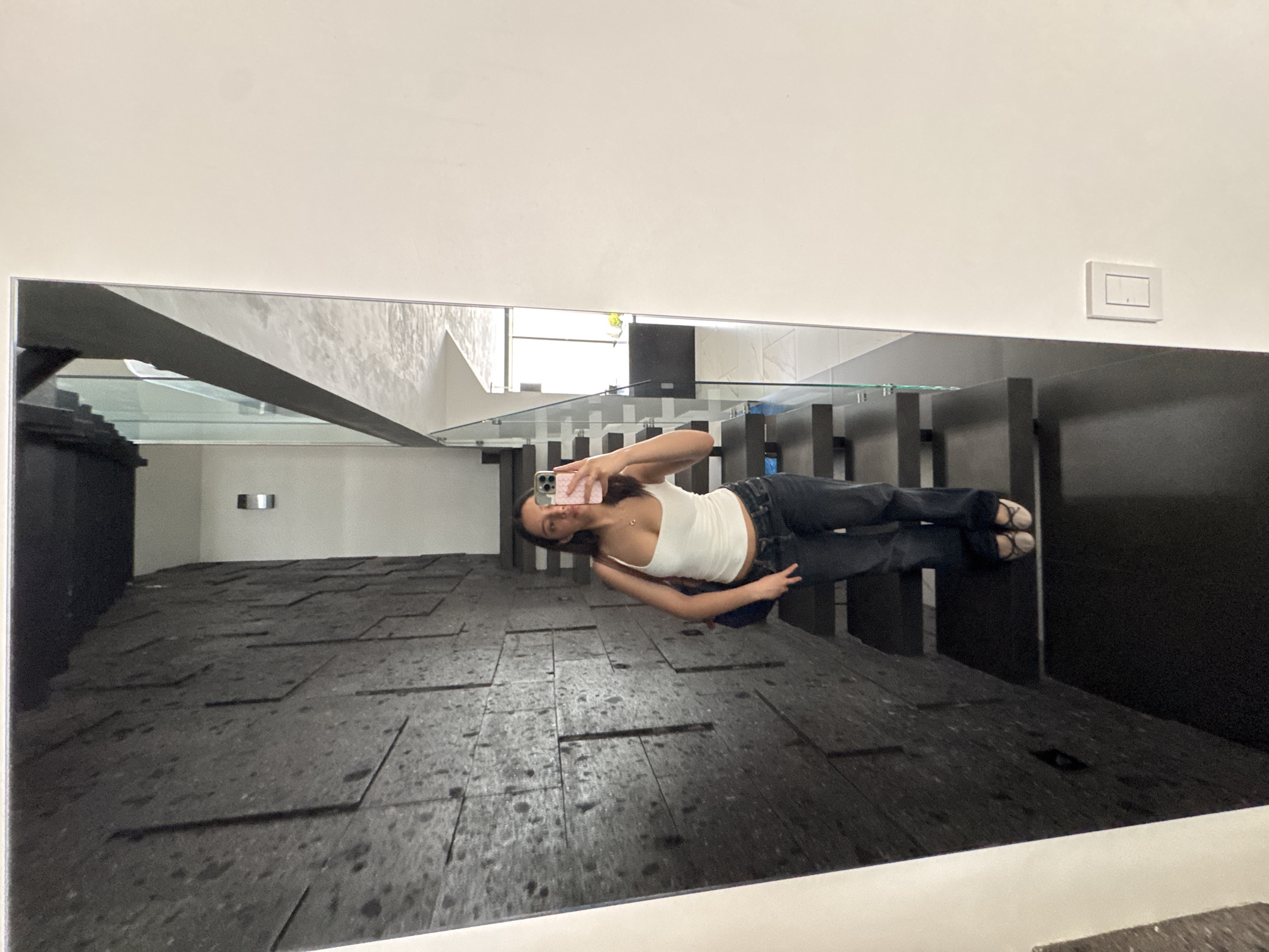 Woman takes mirror selfie in Puebla building
