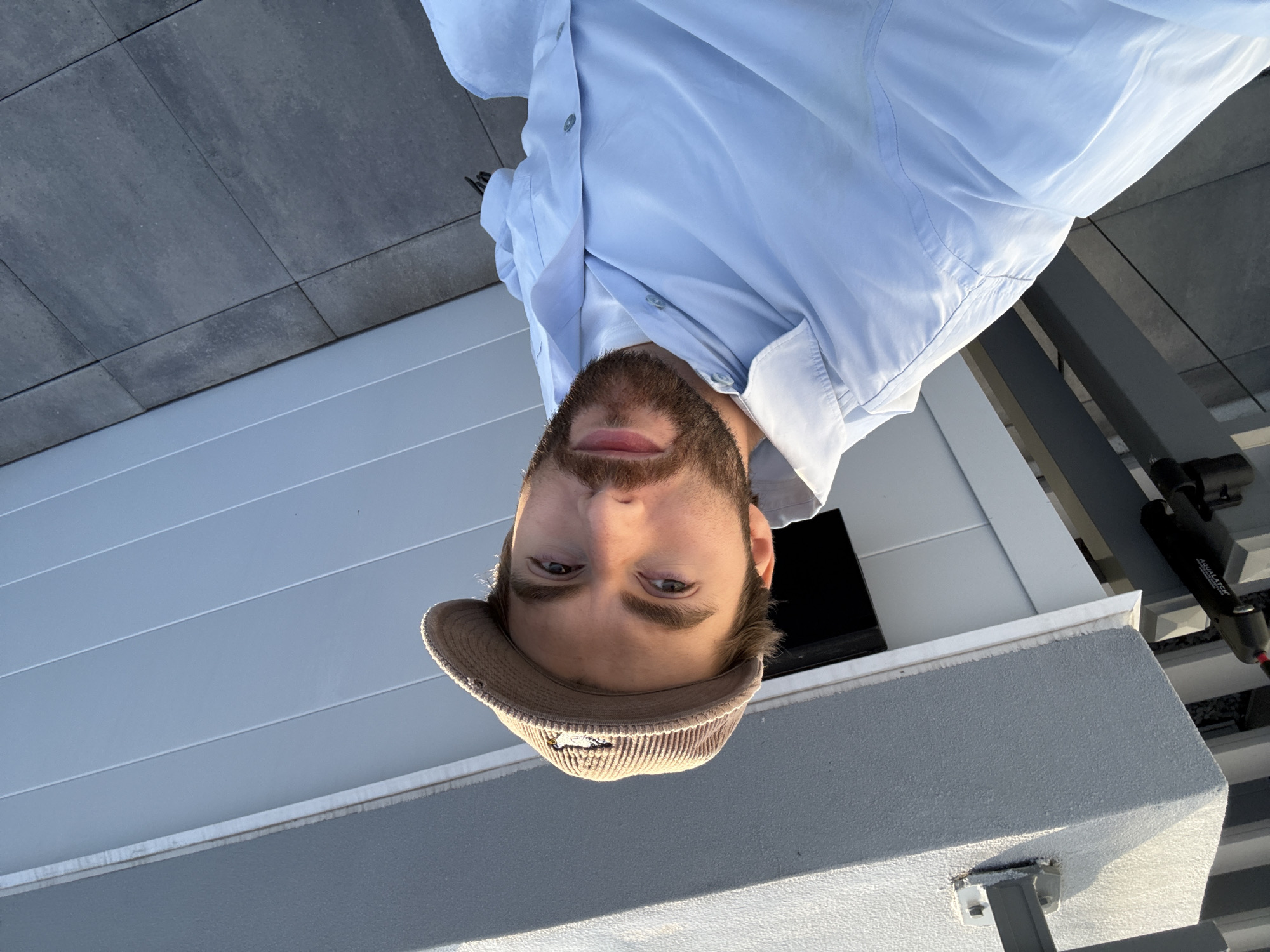 Man on rooftop balcony with outdoor kitchen in Laval