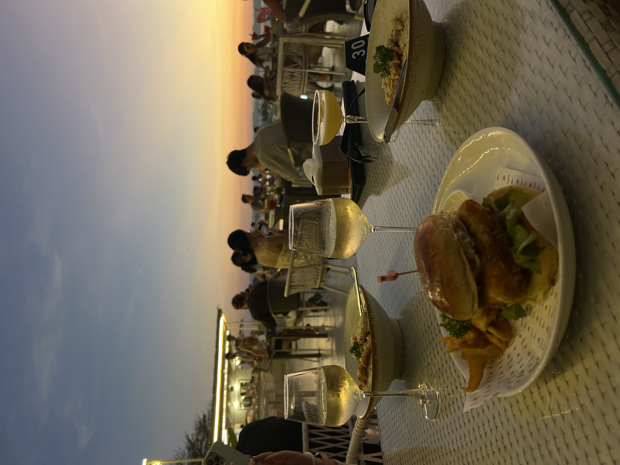 Outdoor dining scene captured at seaside restaurant in Thailand