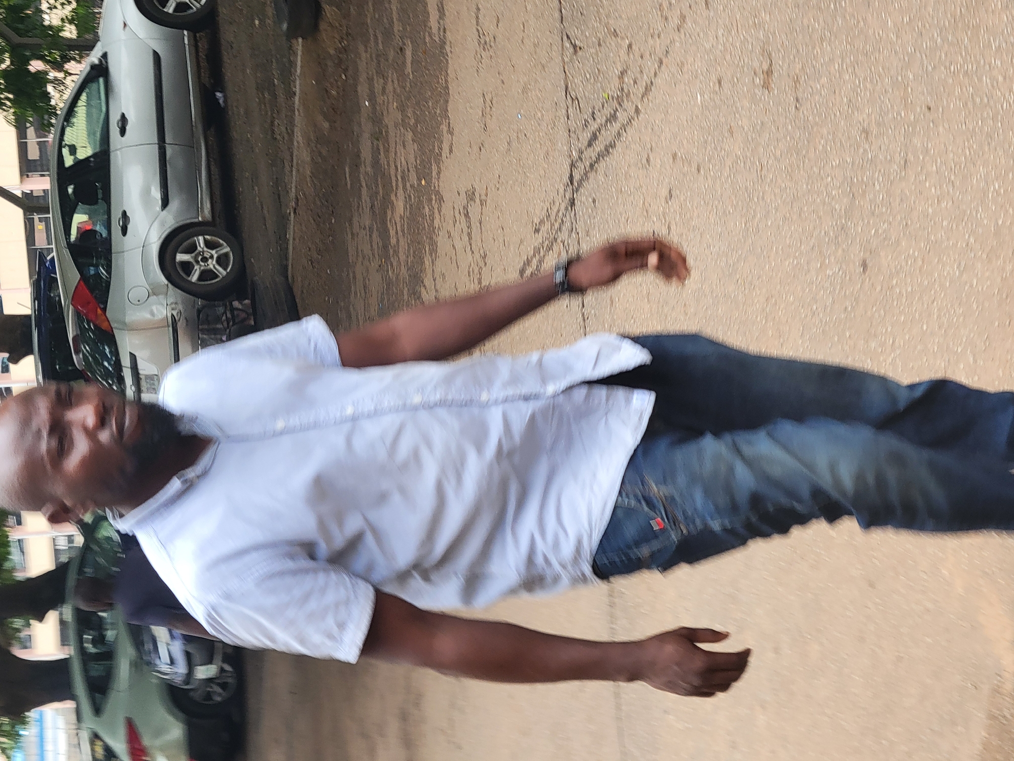 People gather under tree in Abuja outdoor area