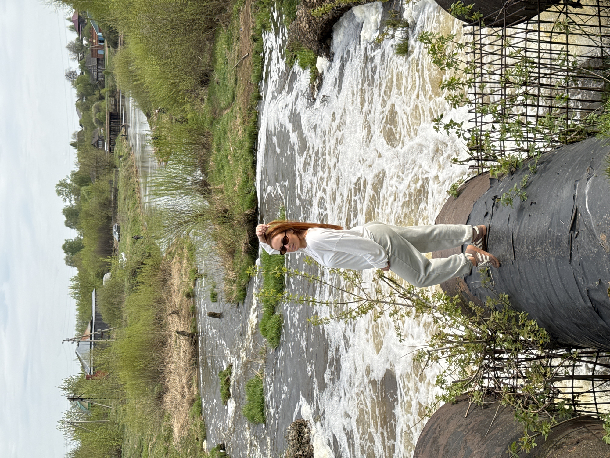 Woman photographed on dam walkway in Nozhovka, Russia