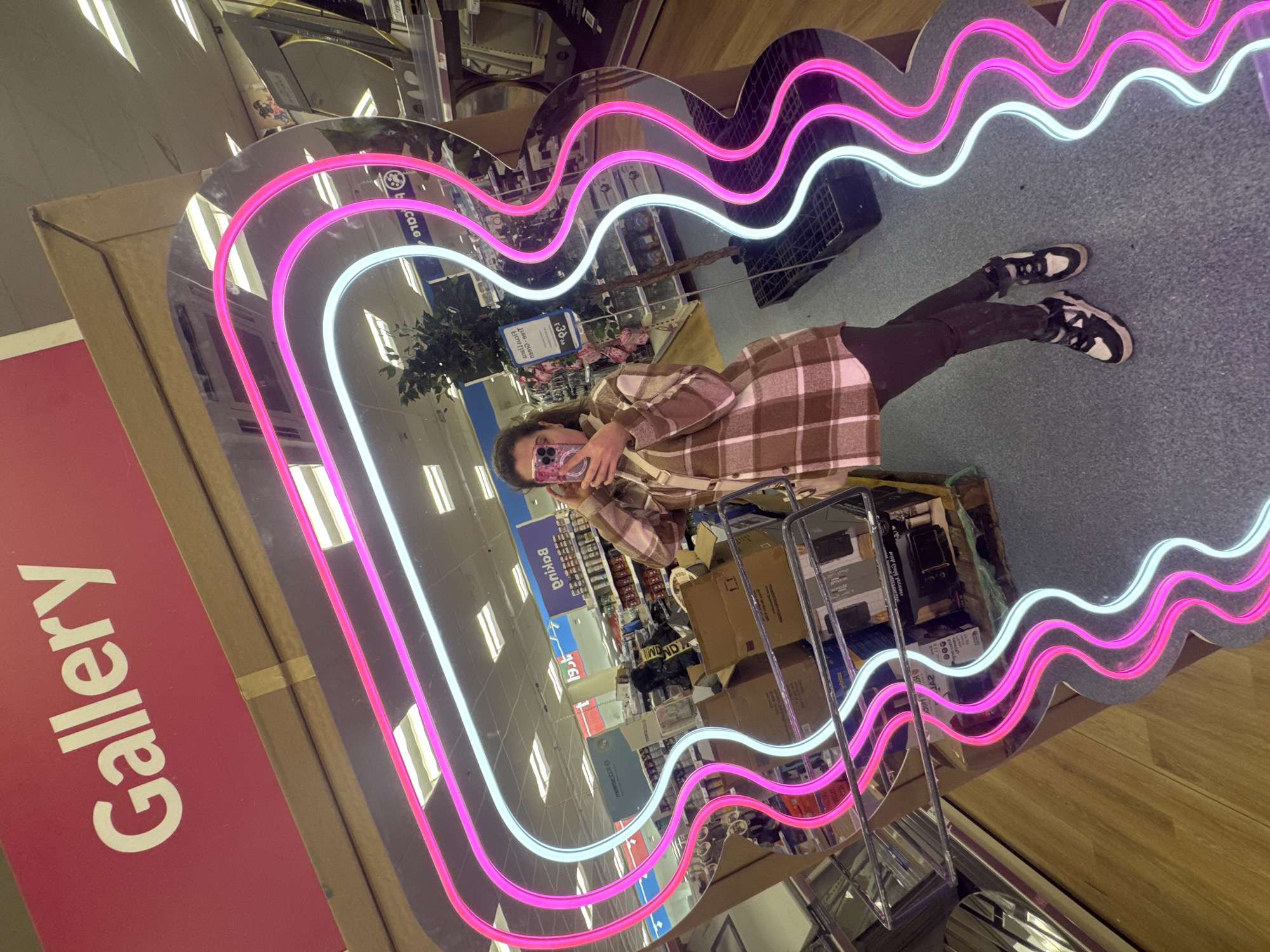 Person takes selfie in heart-shaped neon mirror in Portadown