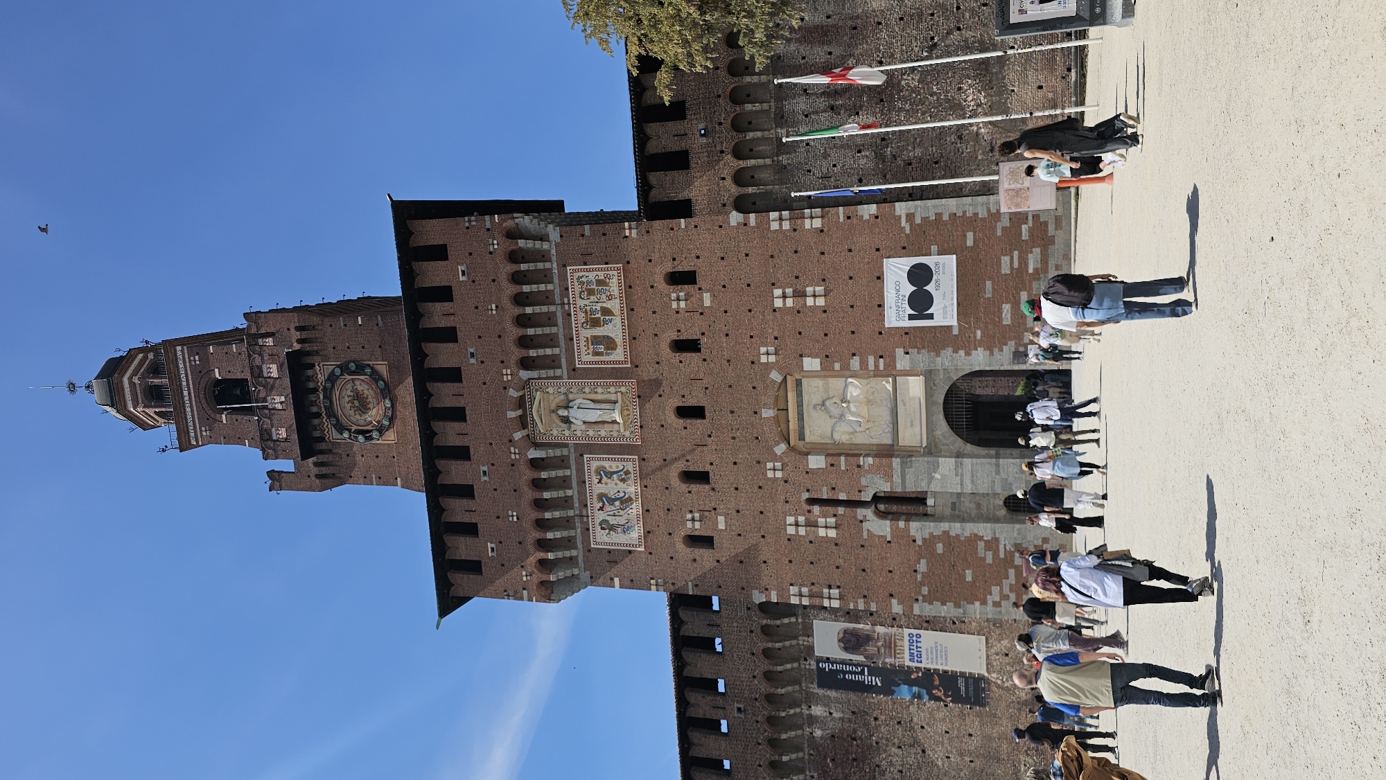 Tourists gather at Milan's historic Sforza Castle Saturday afternoon
