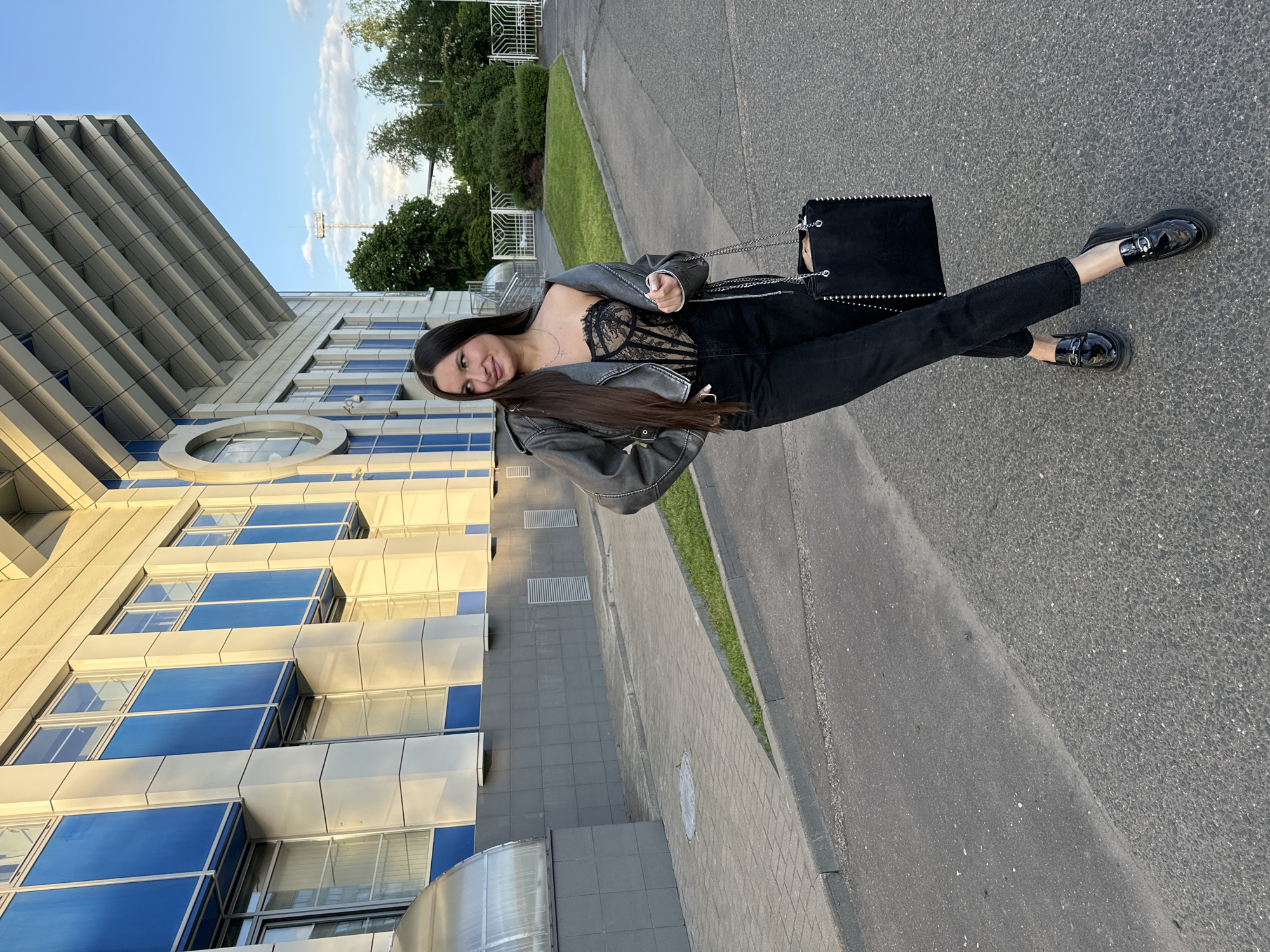 Woman poses for photos in Odintsovo street scene