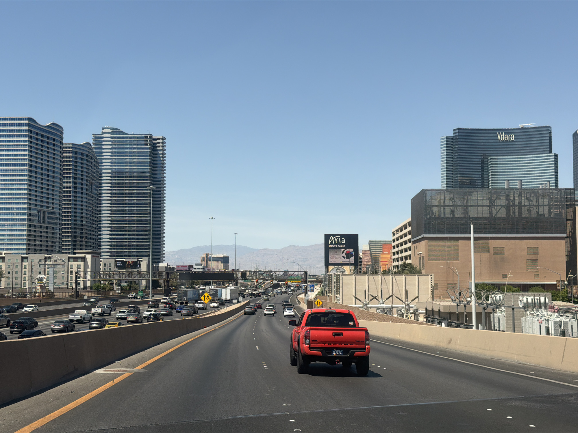 Red pickup truck drives on Paradise Nevada highway
