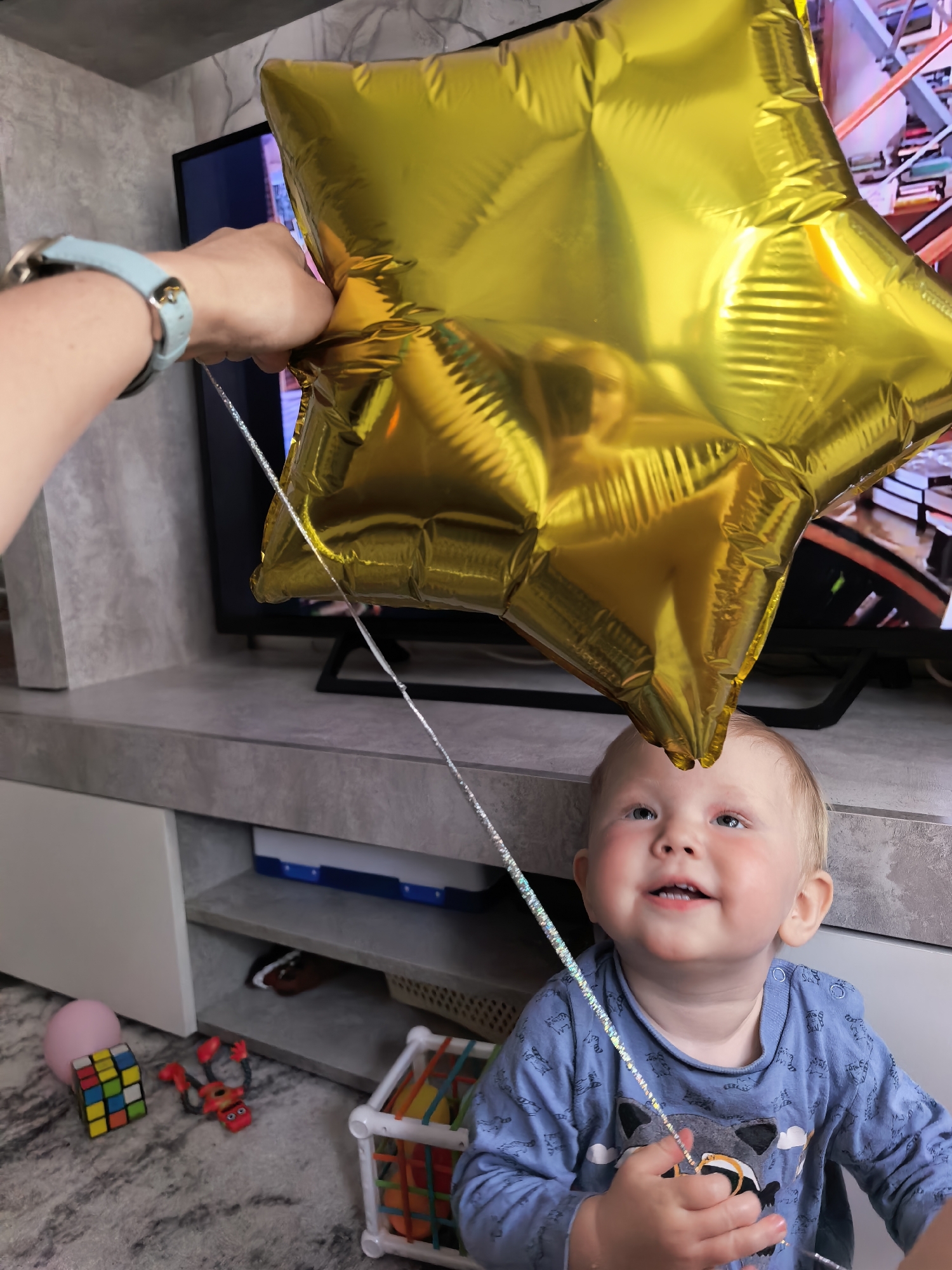 Toddler plays with balloons, toys during family time in Sterlitamak