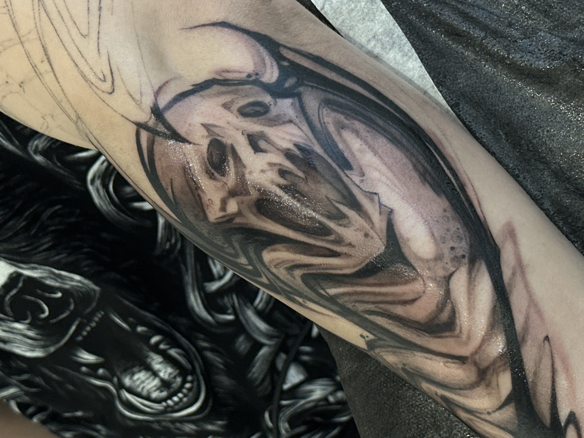Partial skull tattoo documented in progress in Moscow