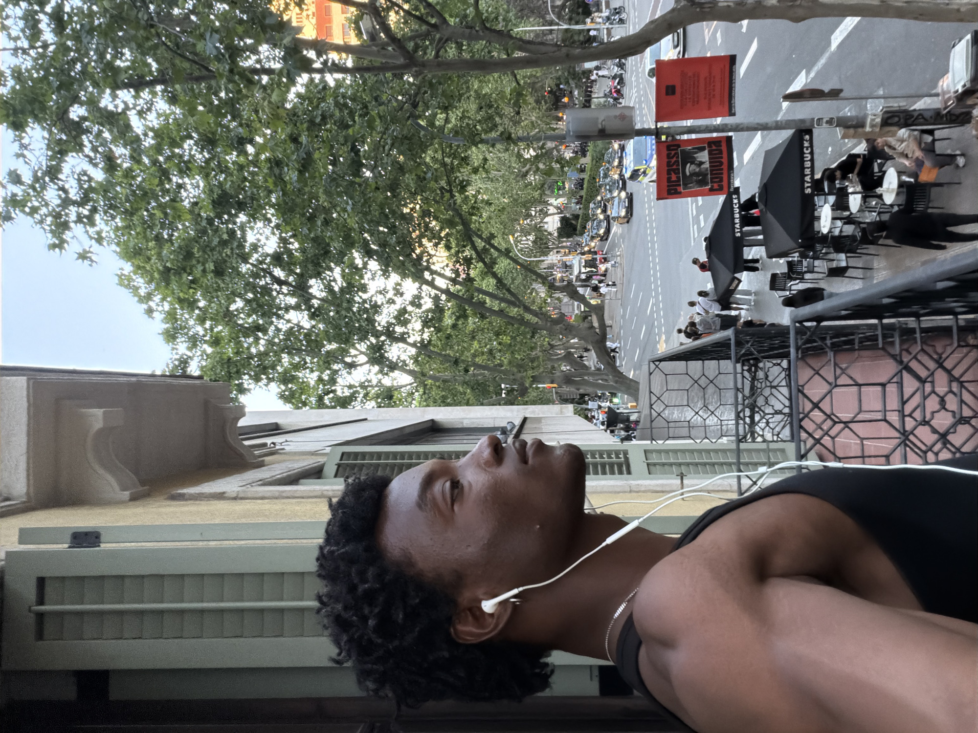 Man with earphones spotted on Barcelona street from balcony view