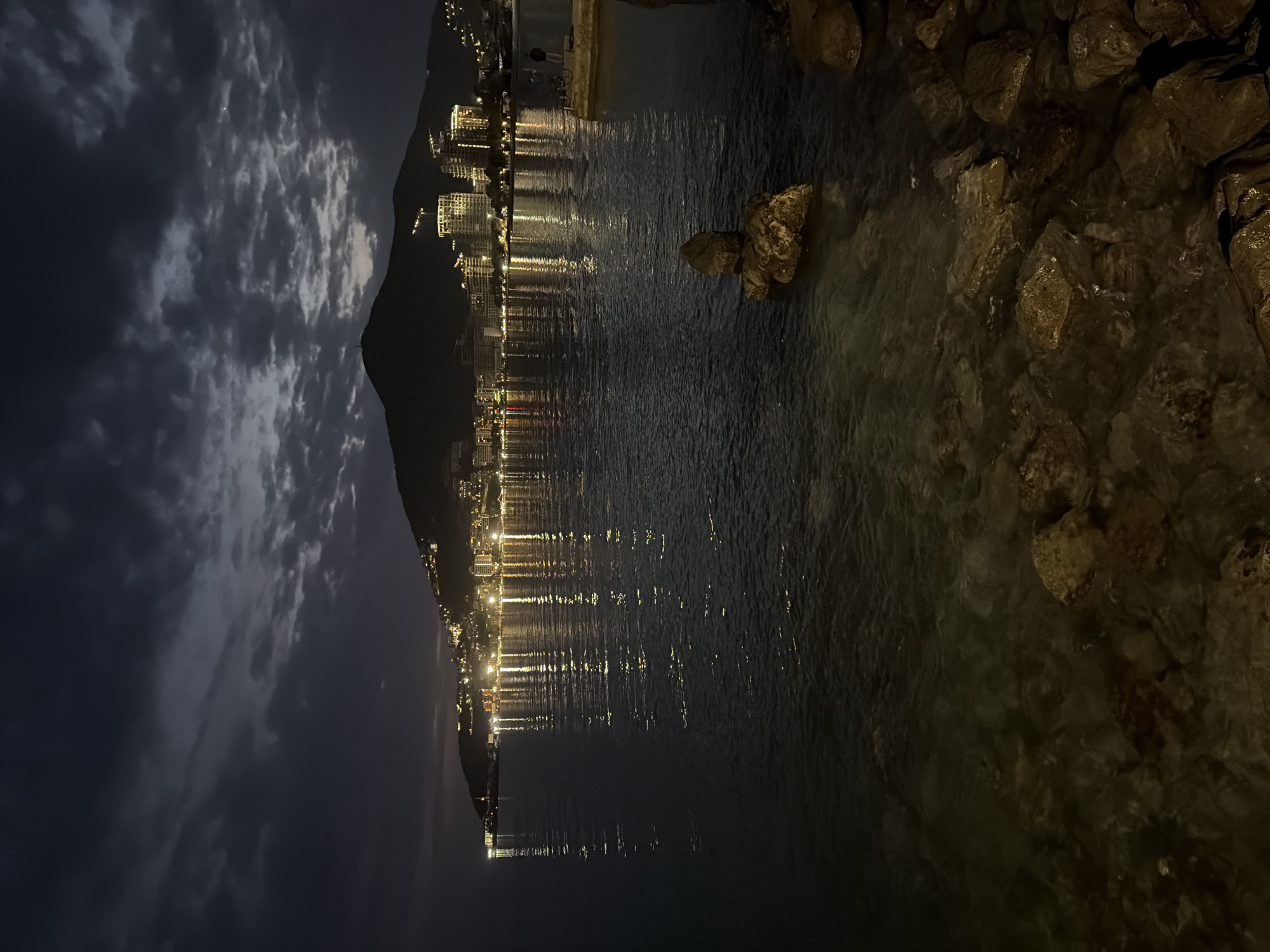 Man cleans sailboat, relaxes by waterfront in Budva