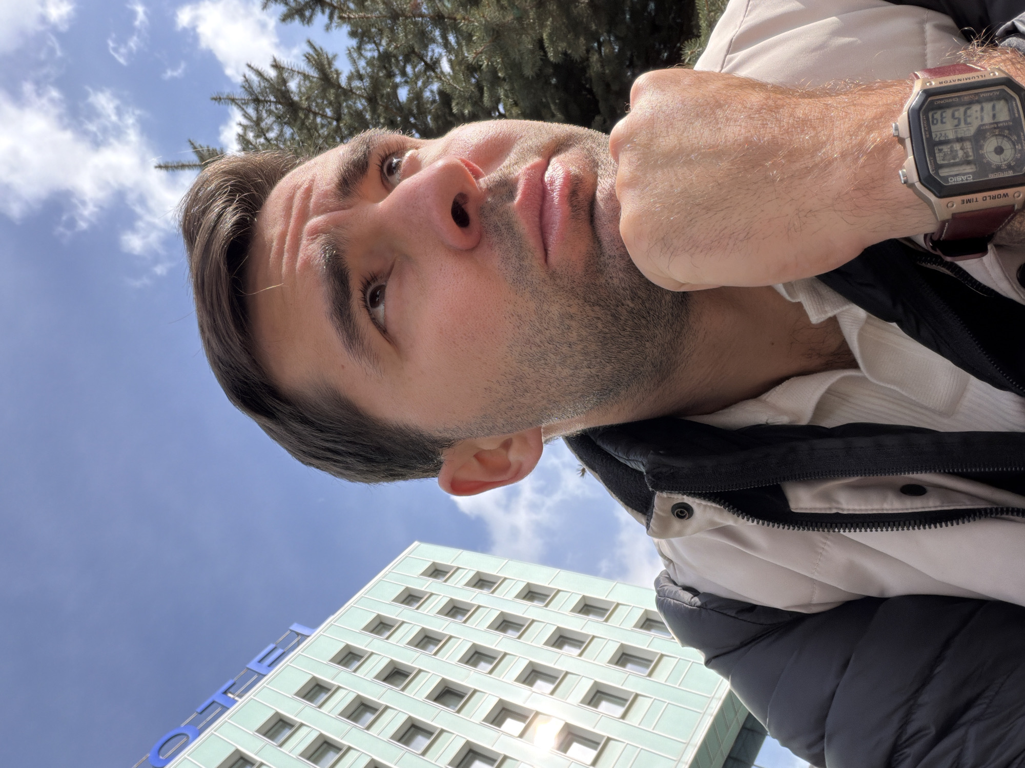 Man takes contemplative selfies near lion statue in Krasnoyarsk