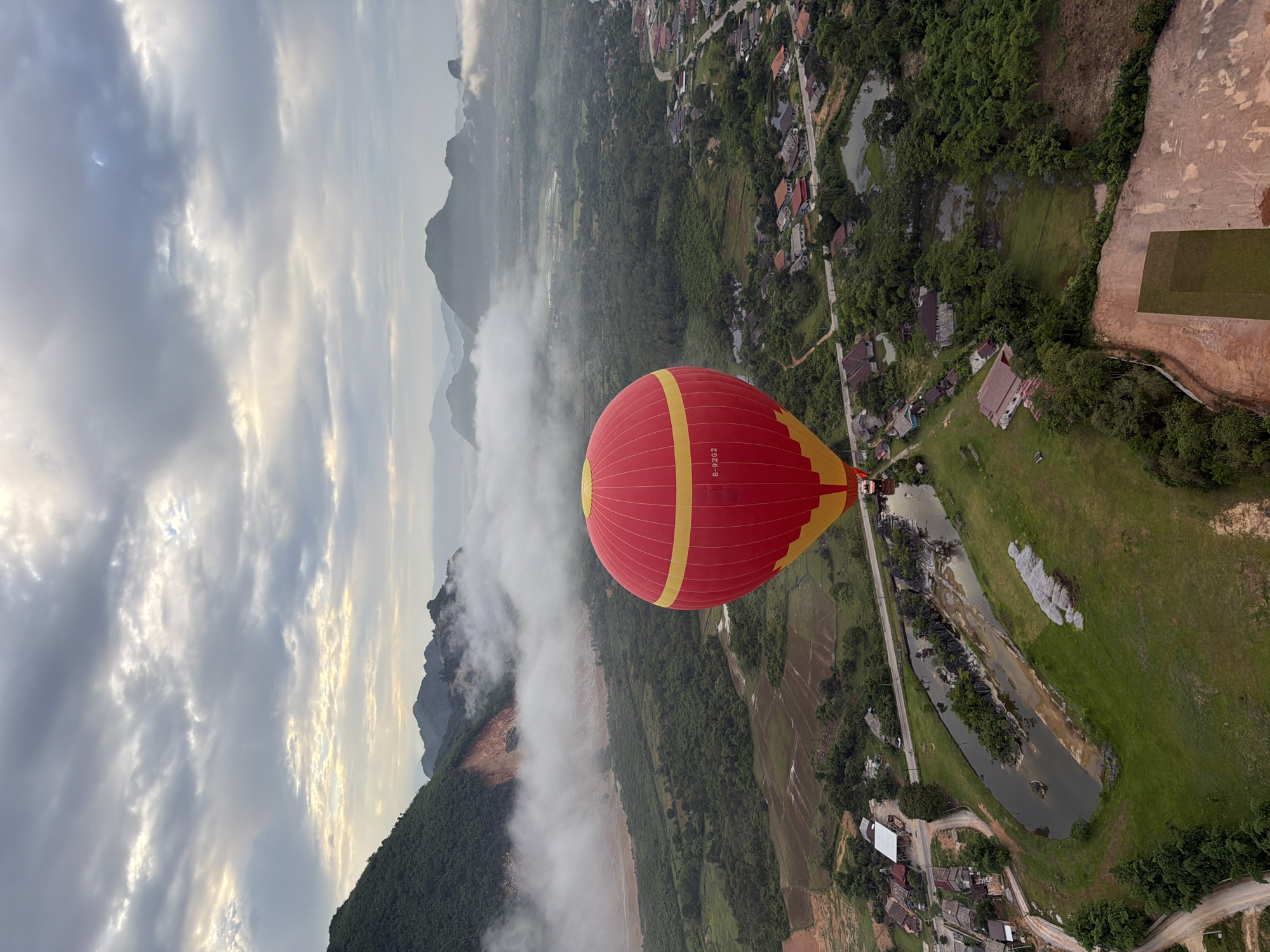 Hot air balloon ride over misty karst mountains near Vang Vieng, Laos