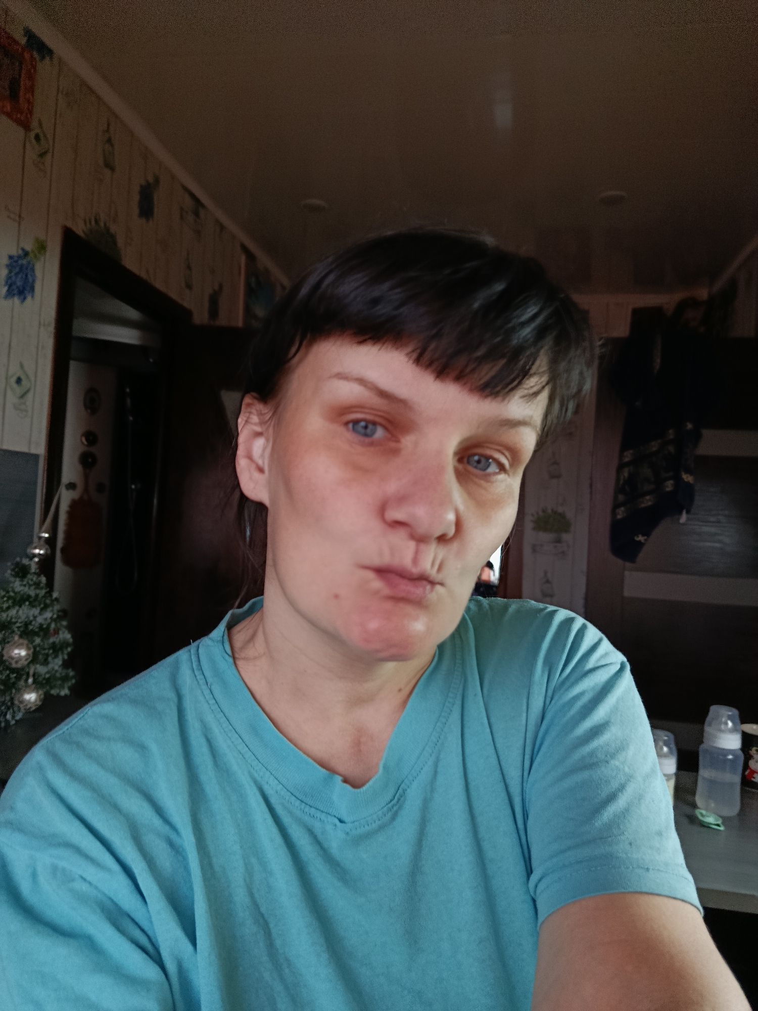 Woman poses playfully for indoor portrait in Foki, Russia