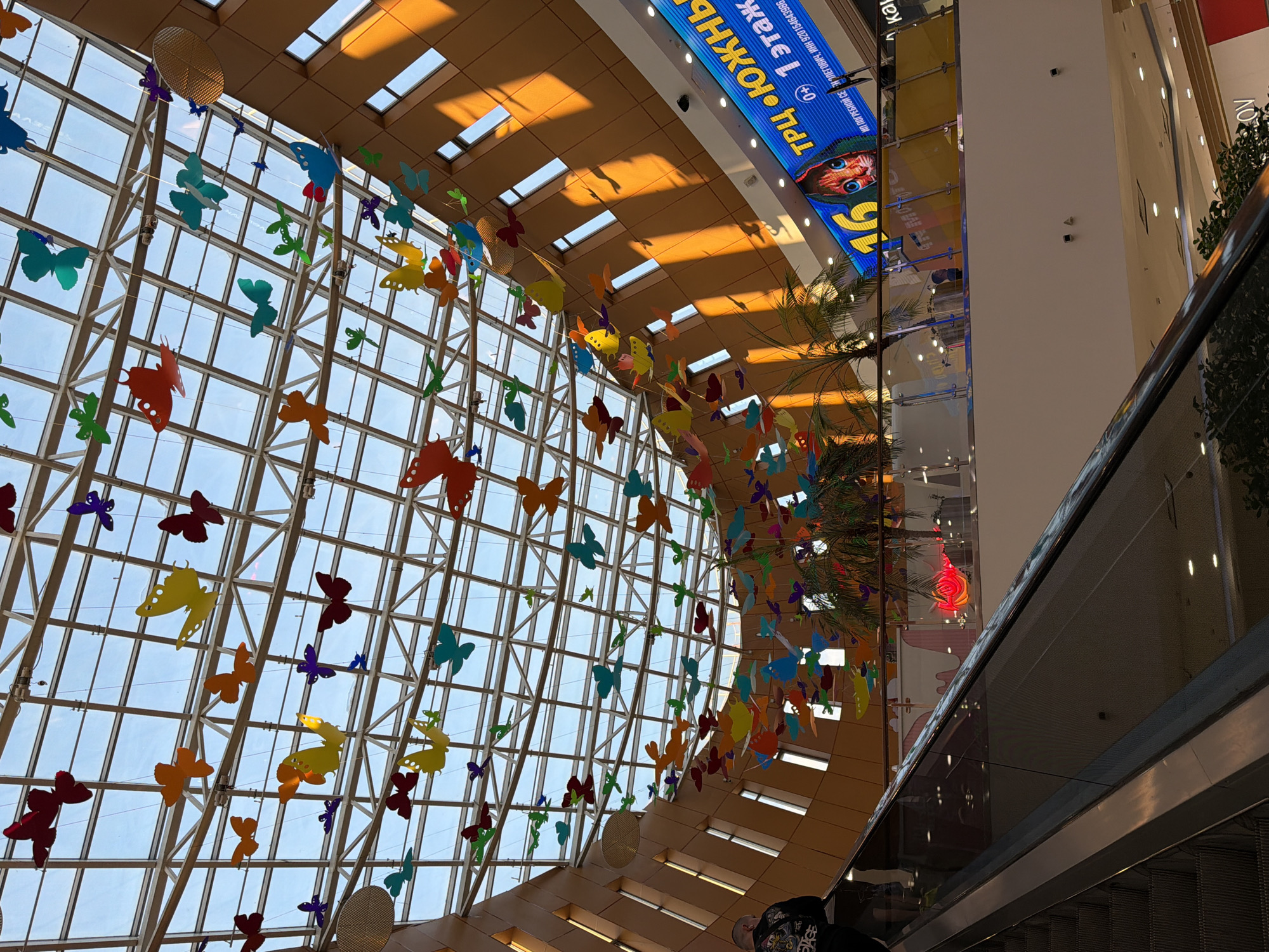Exploring a Russian shopping mall's atrium, shops, and attractions