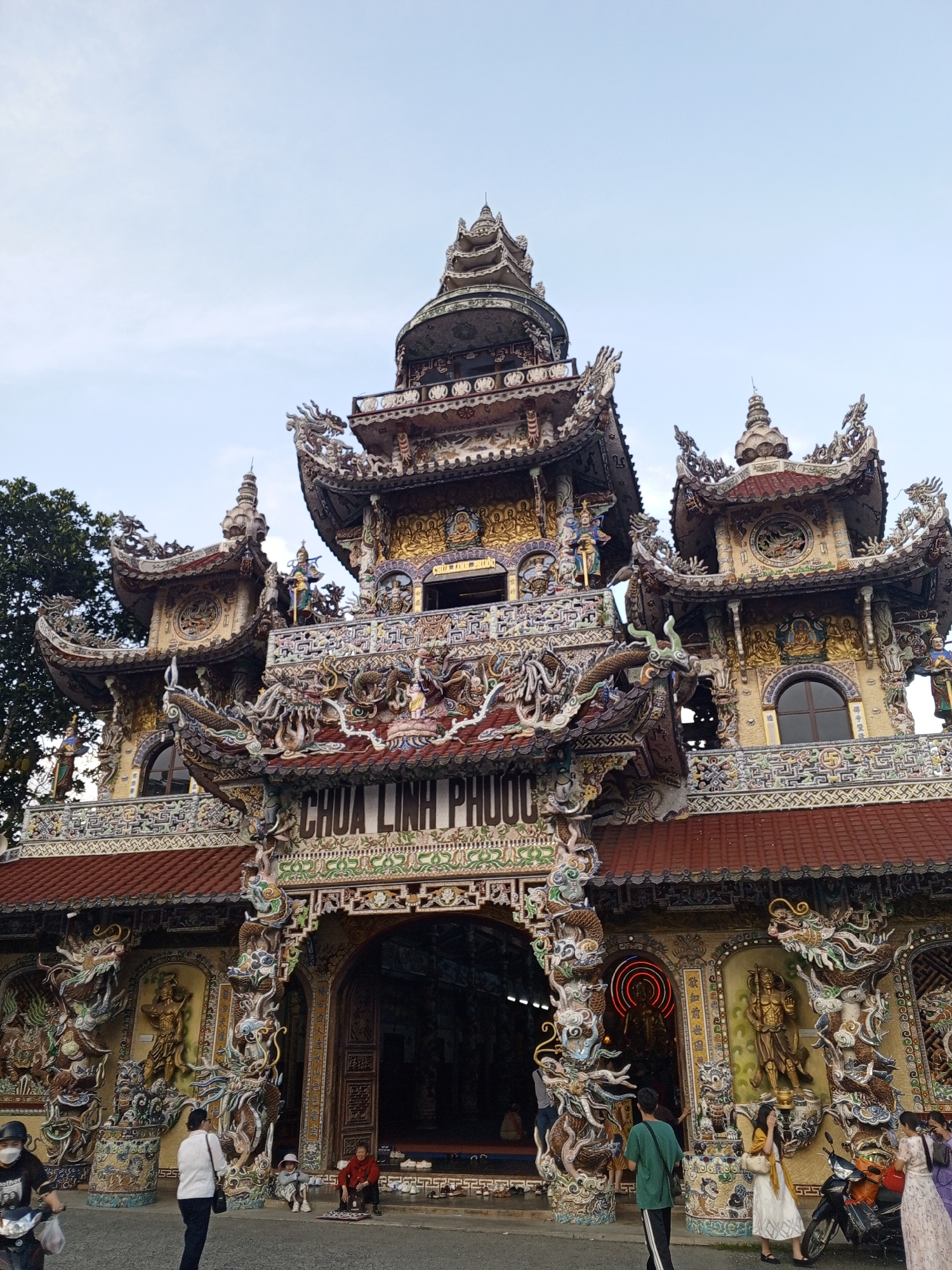 Tourist documents ornate Buddhist temple complex in Vietnam
