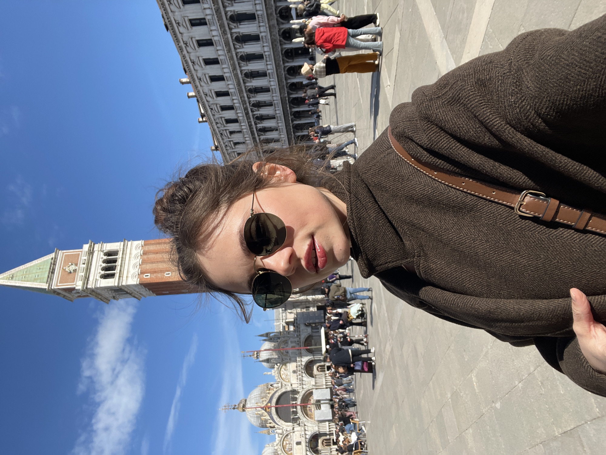 Tourists photograph St. Mark's Square landmarks in Venice