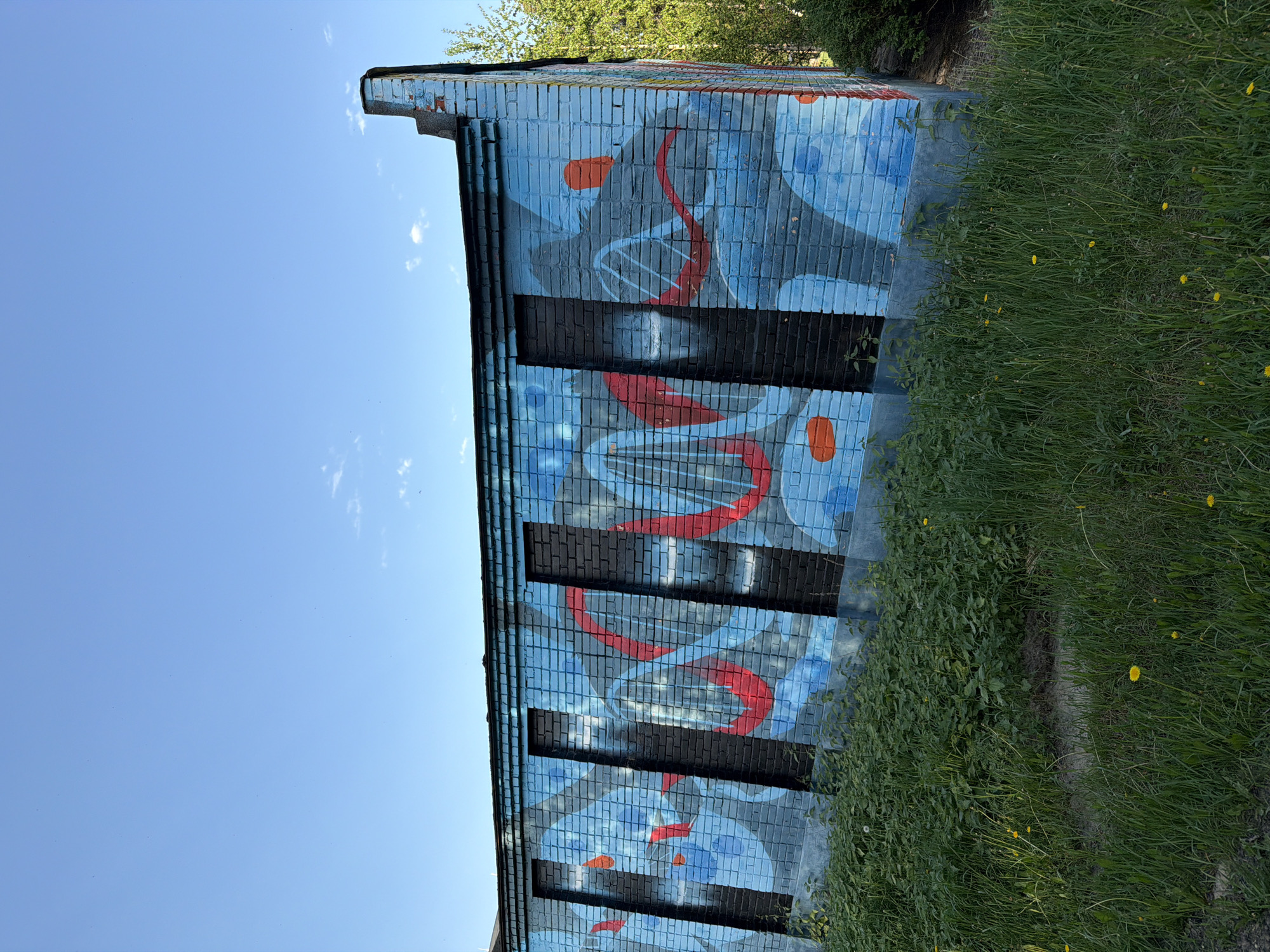 Urban scenes captured: DNA mural, park pathway, industrial pipes