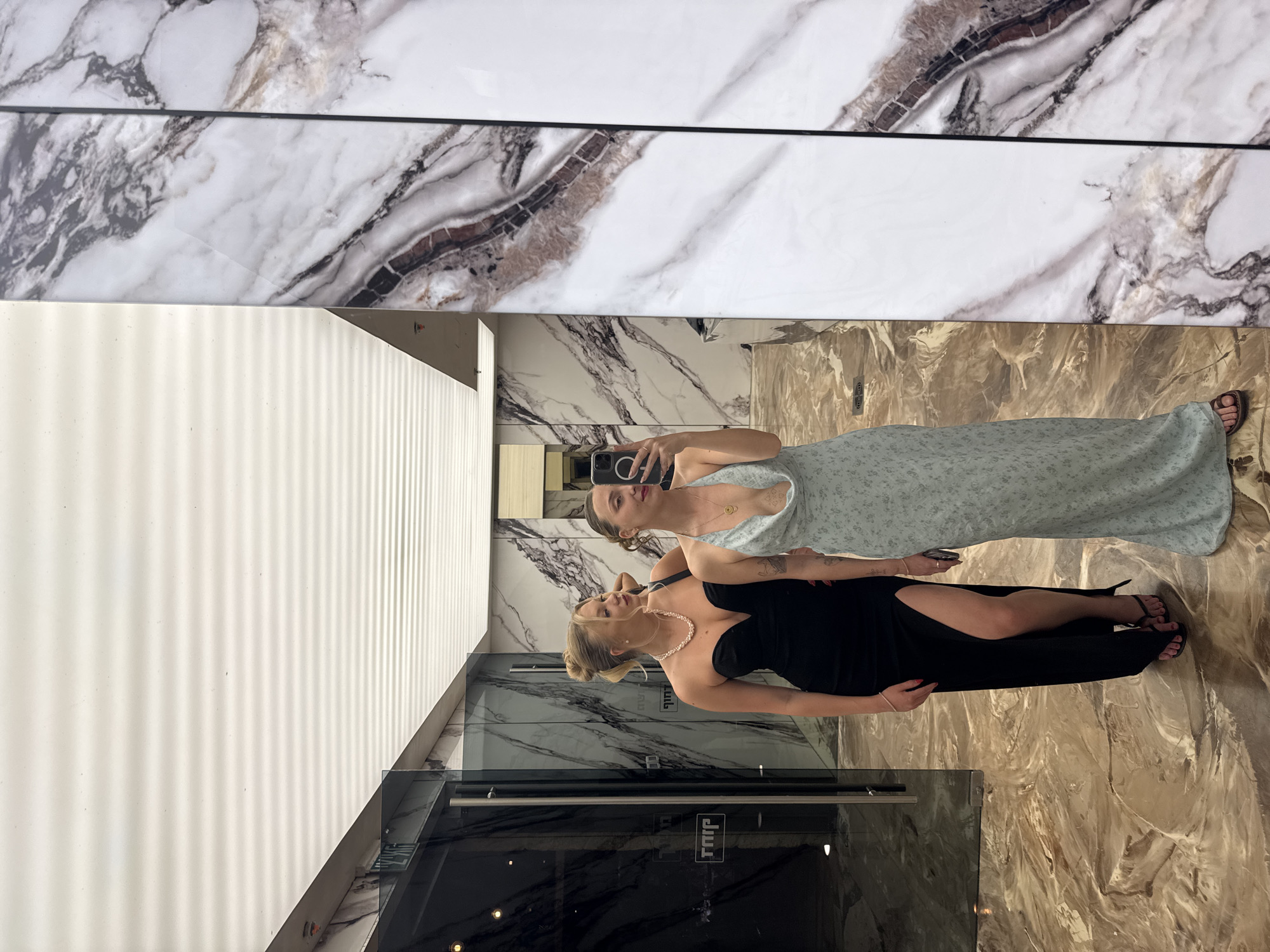 Two women take selfie at mirrored wall in Israel