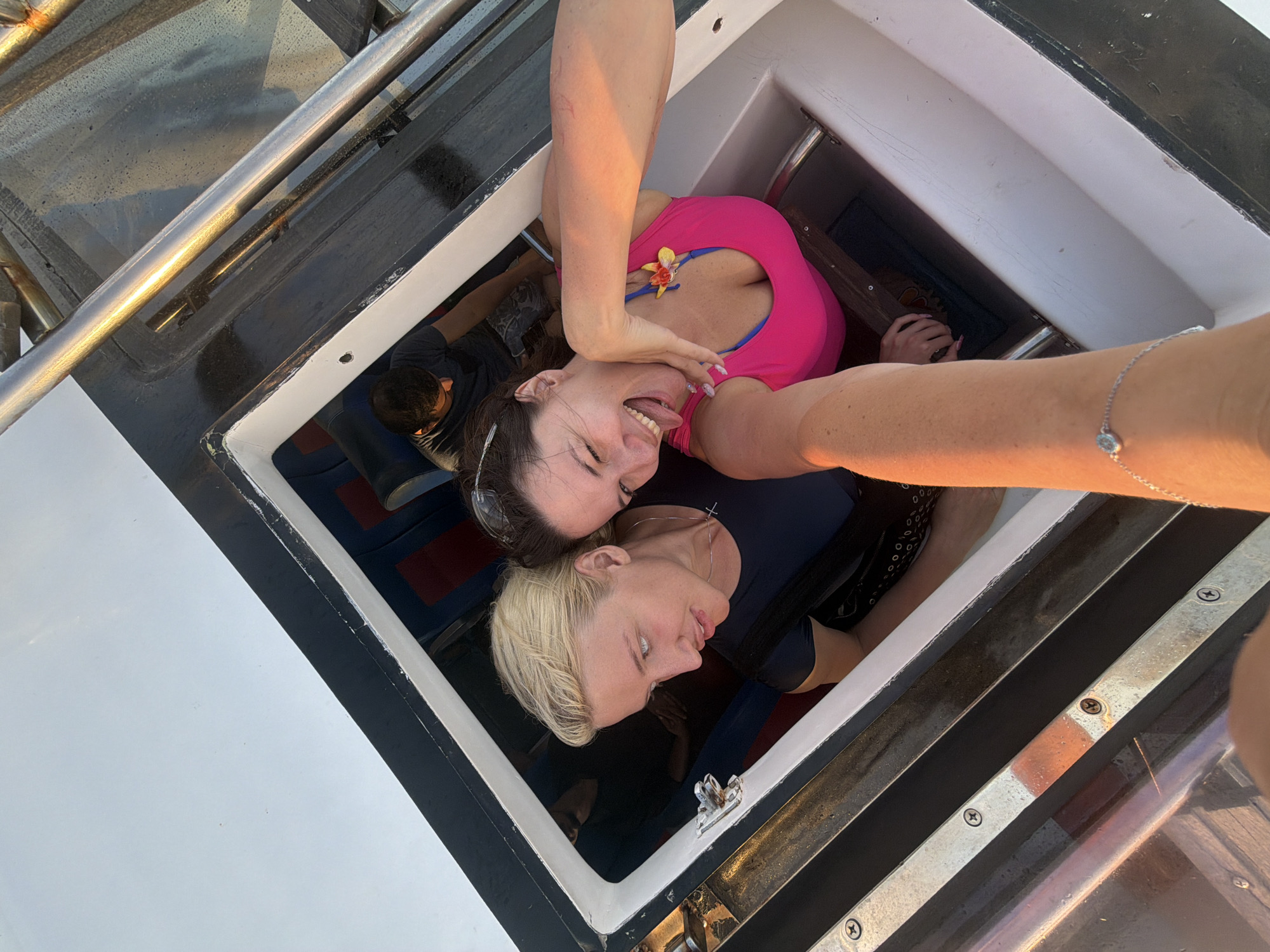 Tourists enjoy boat tour selfies off Denpasar coast