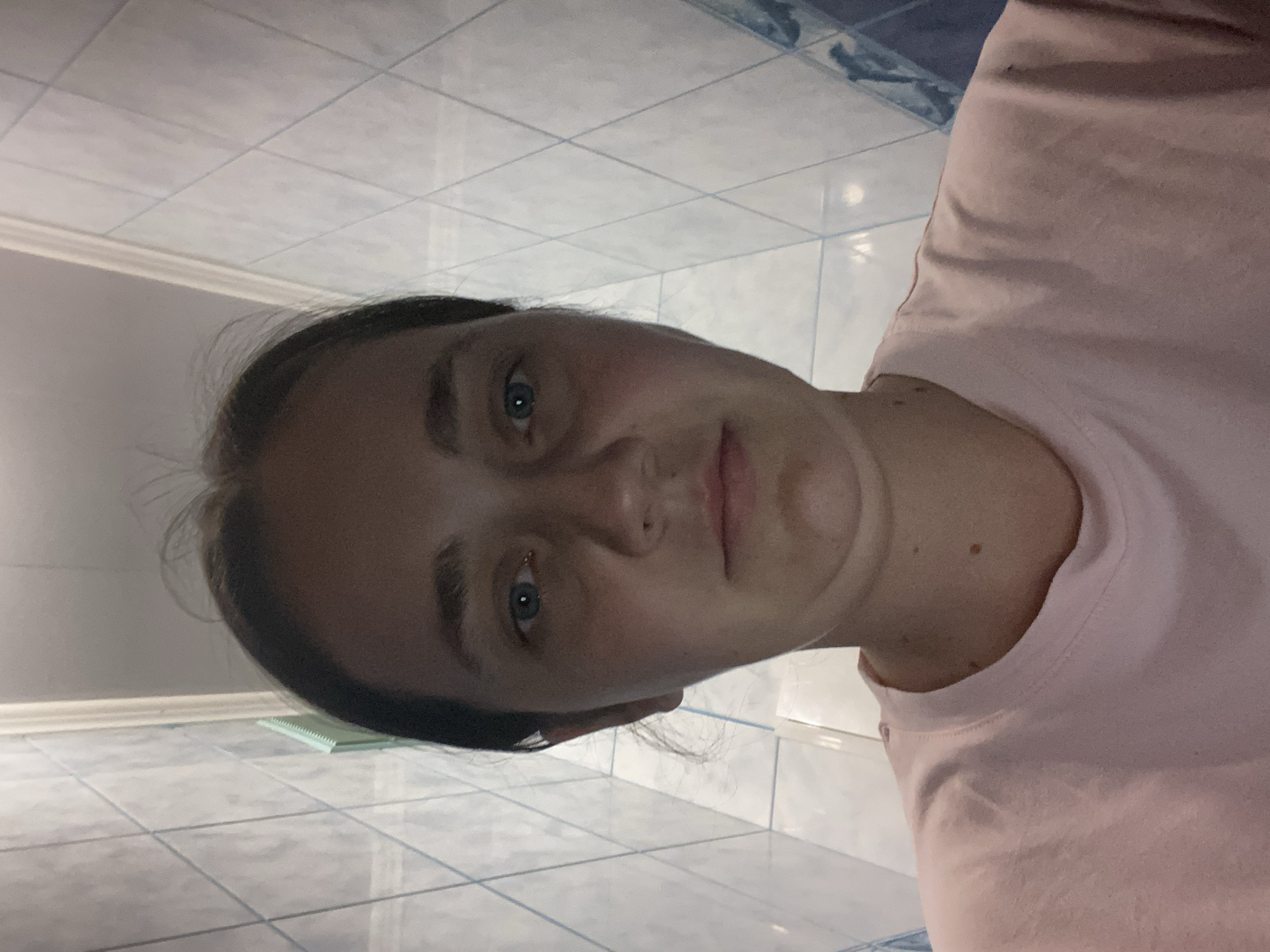 Indoor selfie session in a pink graphic tee, various angles