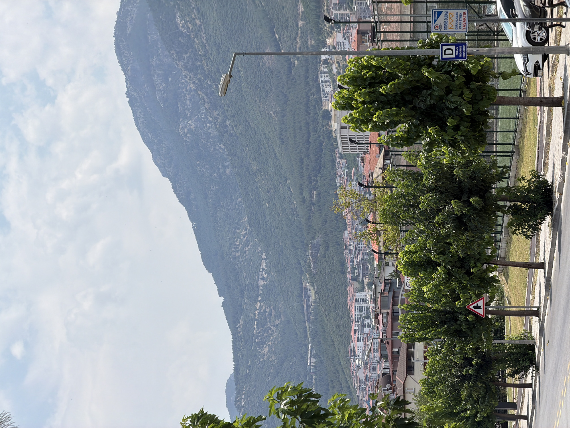 Street-level look at a Denizli neighborhood with municipal and commercial signage