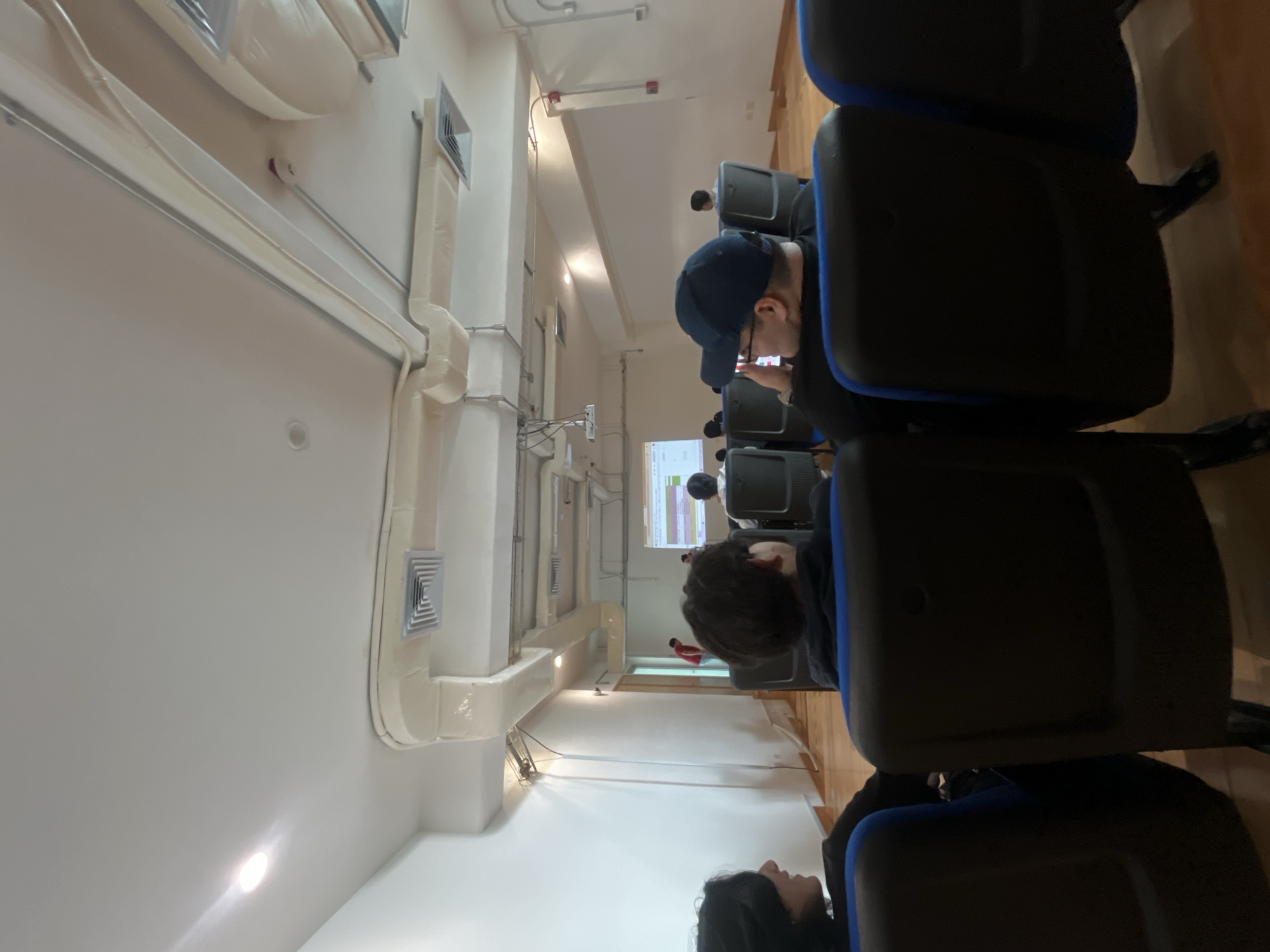 Classroom presentation observed with attendees facing projection screen