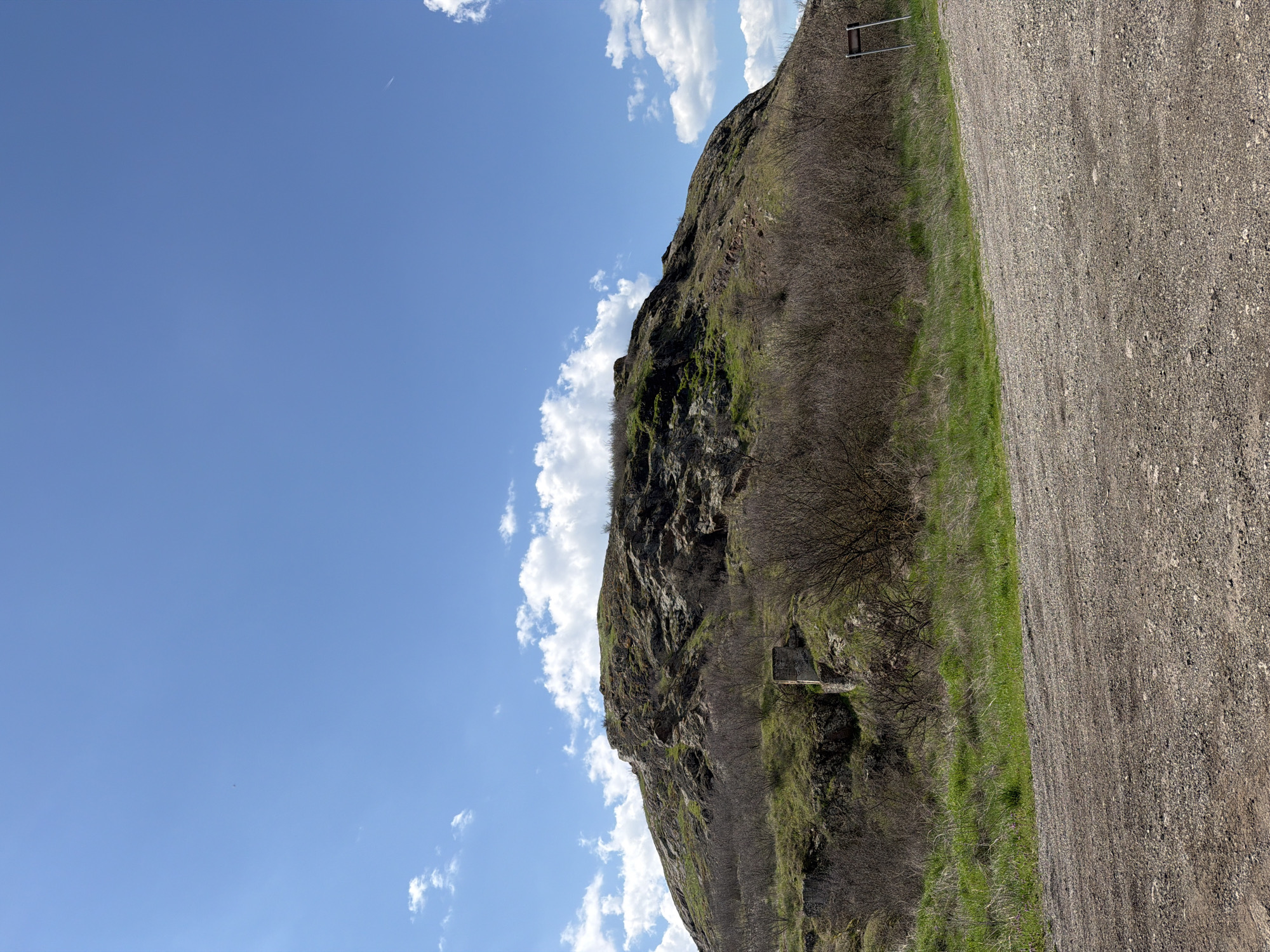 Rocky hillside documented near Rusokastro, Bulgaria under partly cloudy skies